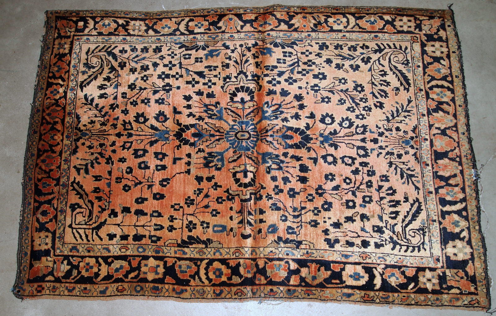 Handmade antique Persian Sarouk rug in original good condition. The rug is from the beginning of 20th century made in pale red wool.