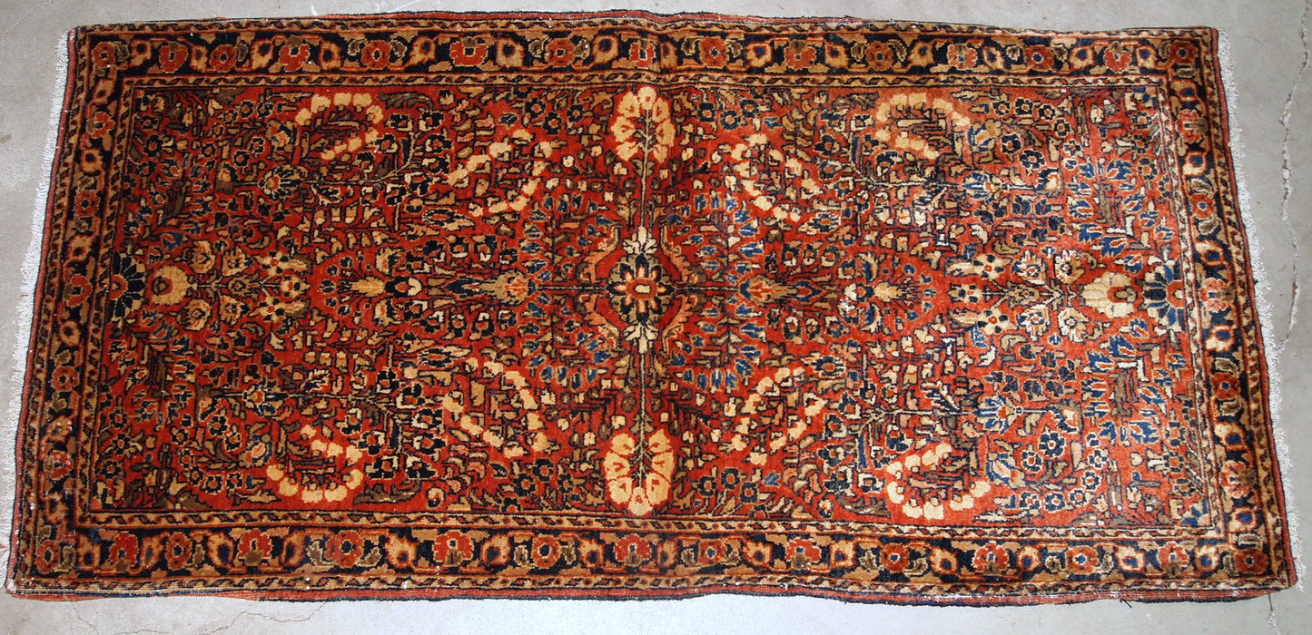 Handmade antique Persian Sarouk rug in original good condition. The rug is from the beginning of 20th century made in red wool.