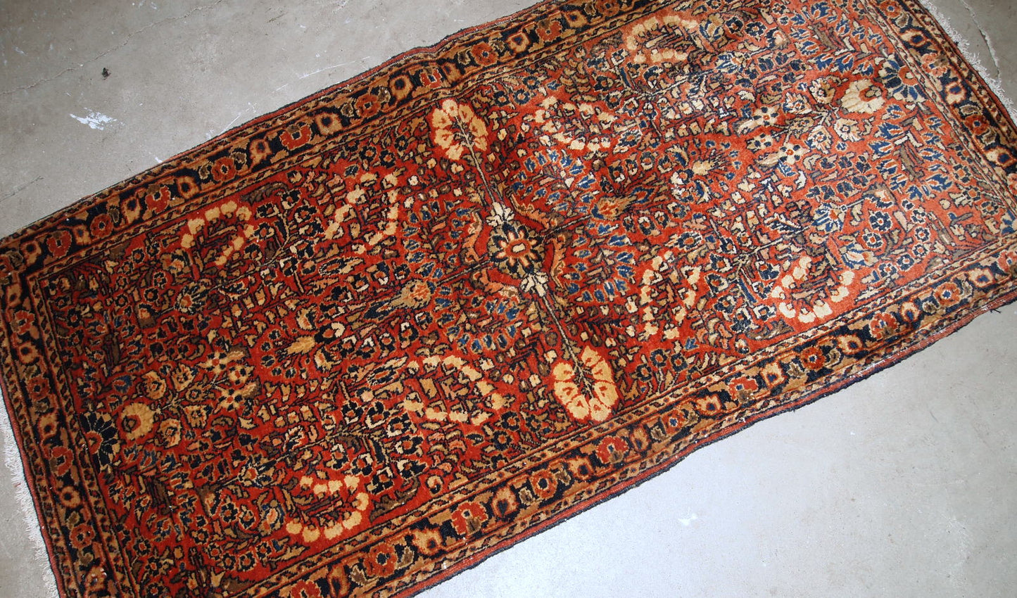 Handmade antique Persian Sarouk rug in original good condition. The rug is from the beginning of 20th century made in red wool.