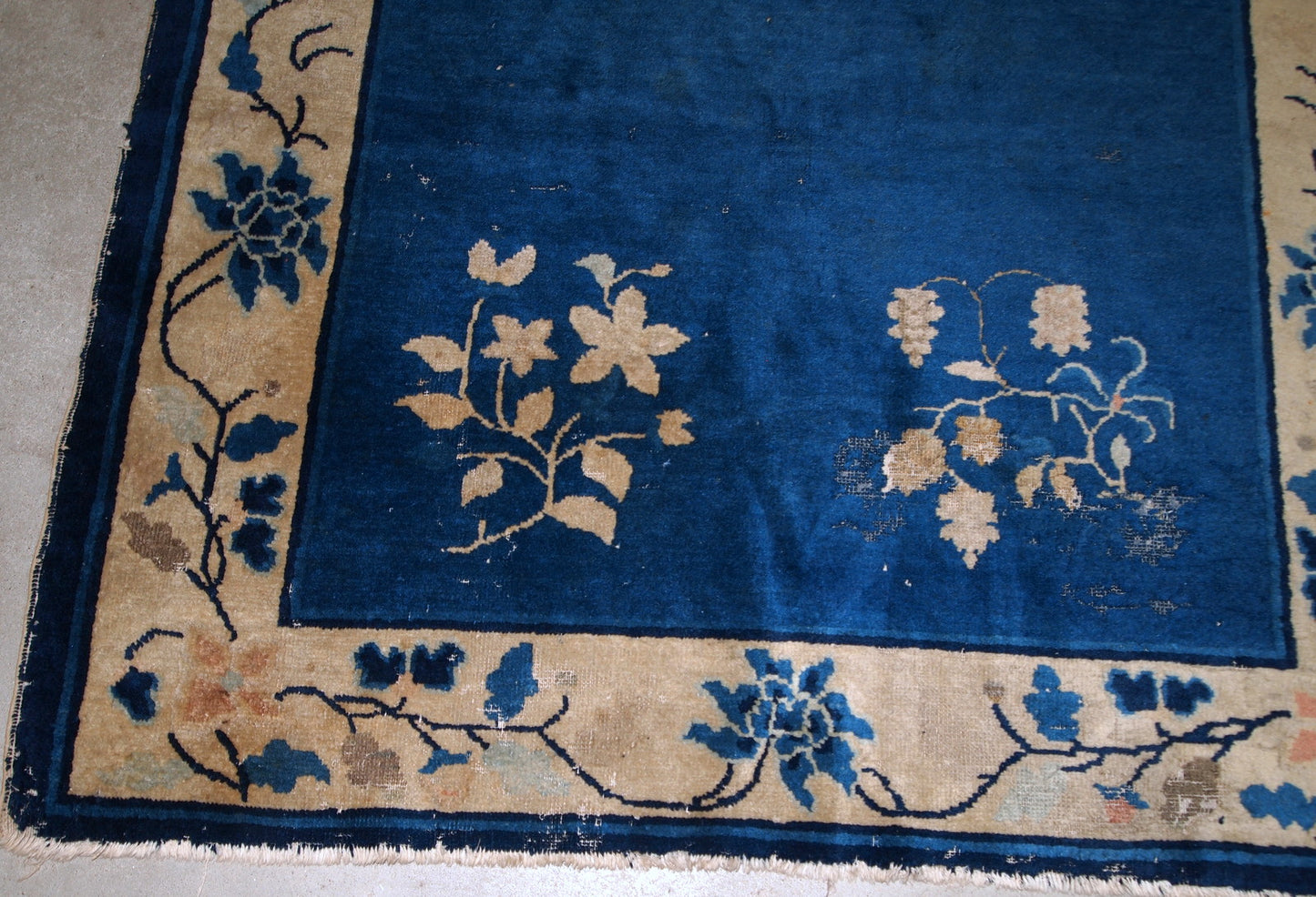 Handmade antique rug from Beijing, China, made in blue wool. The rug is in original condition, has some age wear. It is from the 1900s.