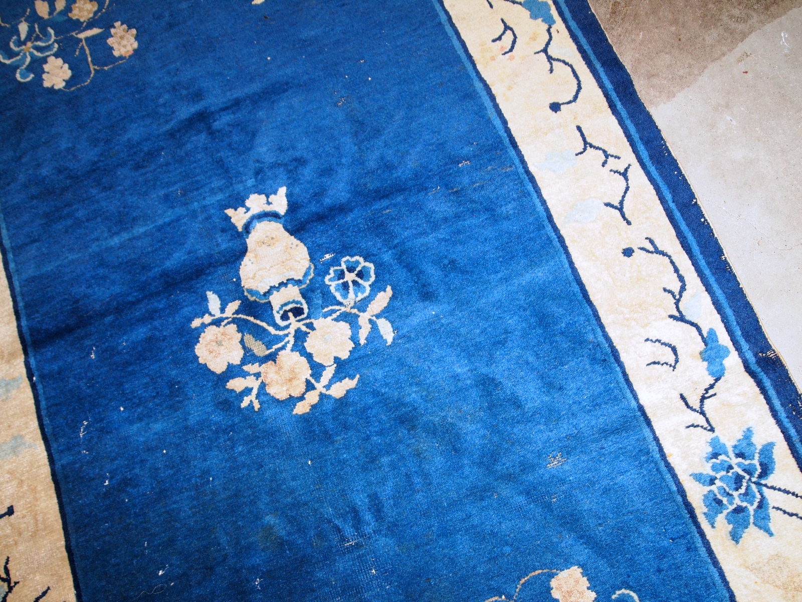 Handmade antique rug from Beijing, China, made in blue wool. The rug is in original condition, has some age wear. It is from the 1900s.
