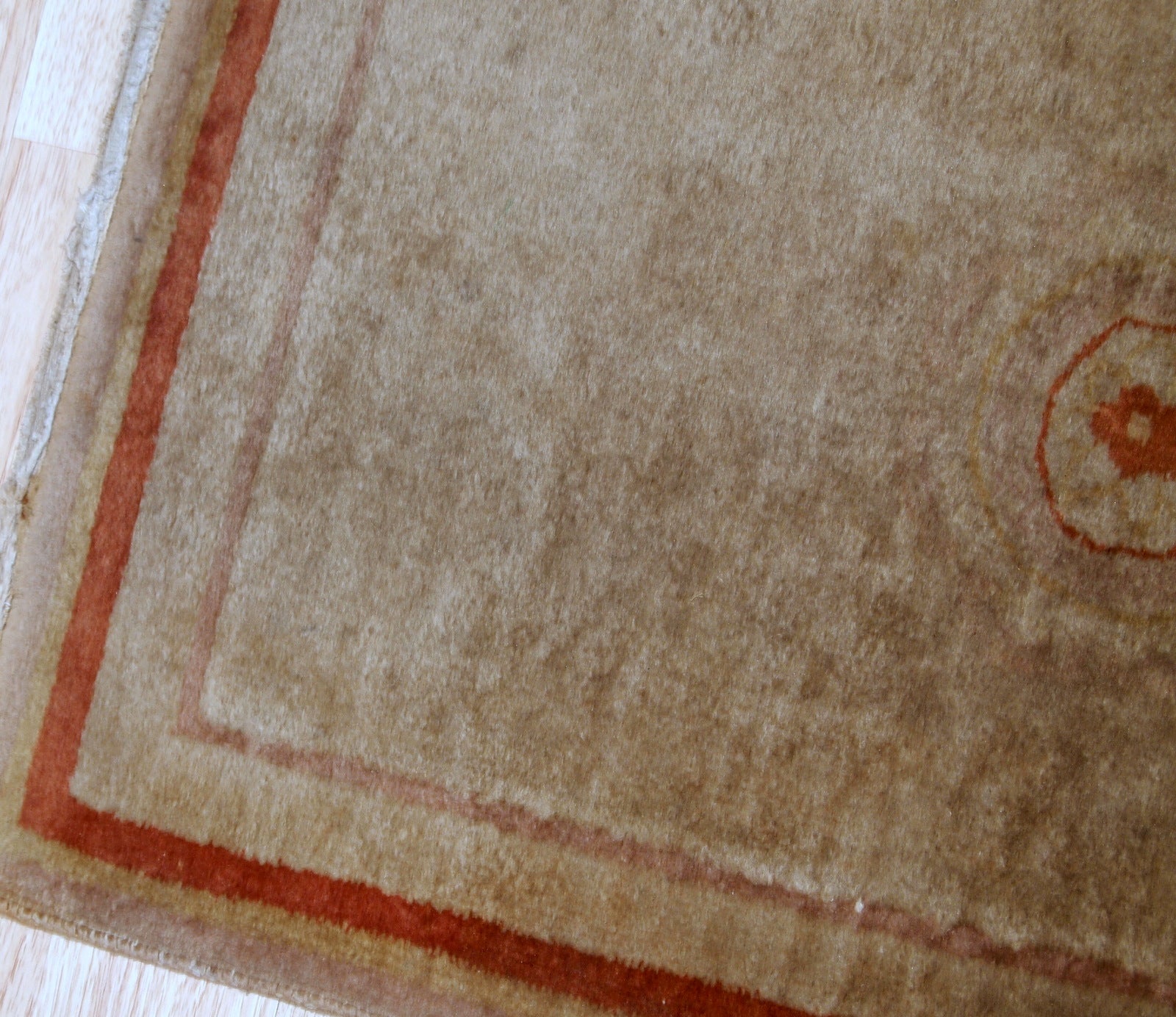 Handmade vintage rug from China made in beige wool. The rug is from the end of 20th century in original good condition.
