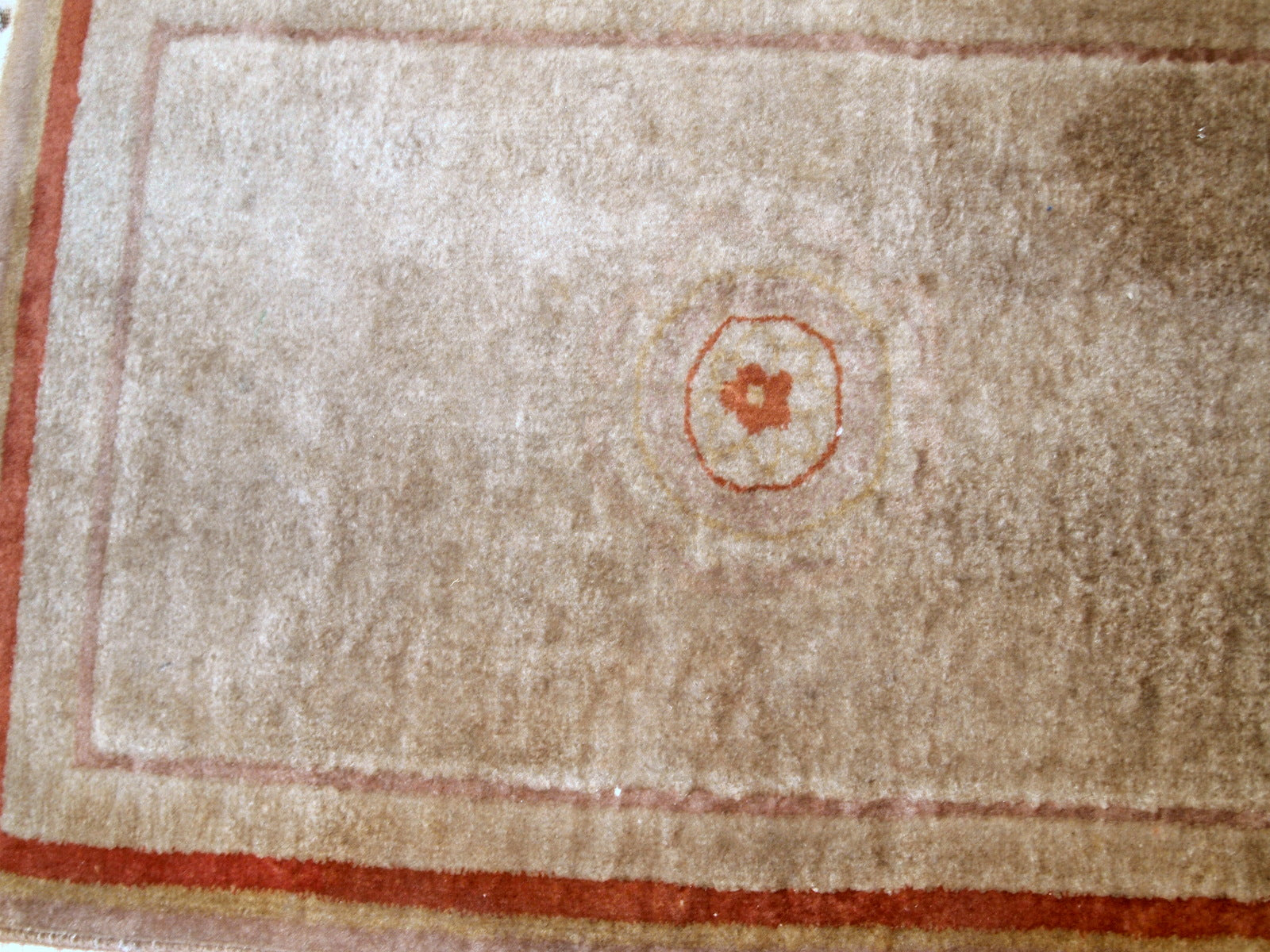 Handmade vintage rug from China made in beige wool. The rug is from the end of 20th century in original good condition.