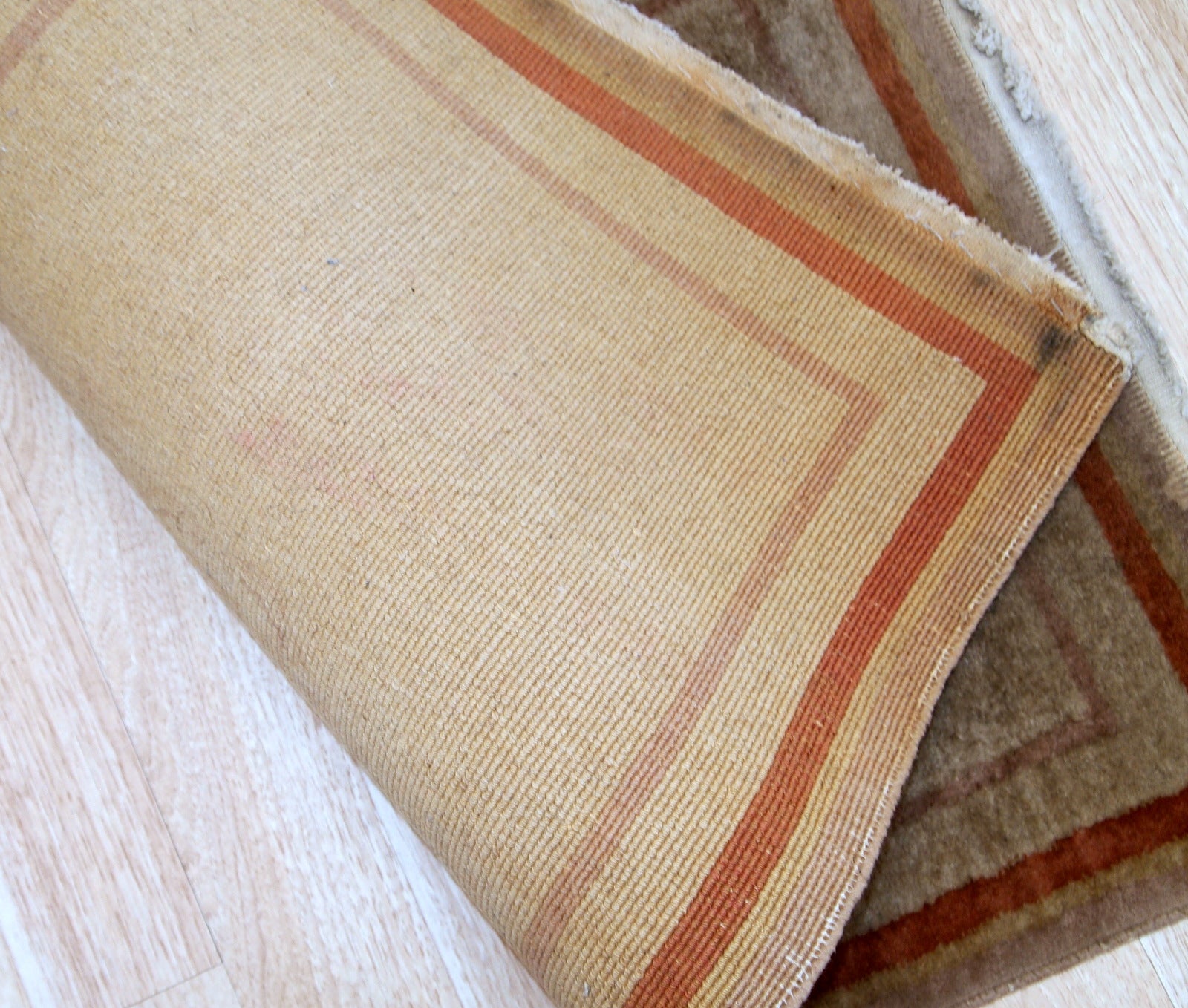 Handmade vintage rug from China made in beige wool. The rug is from the end of 20th century in original good condition.