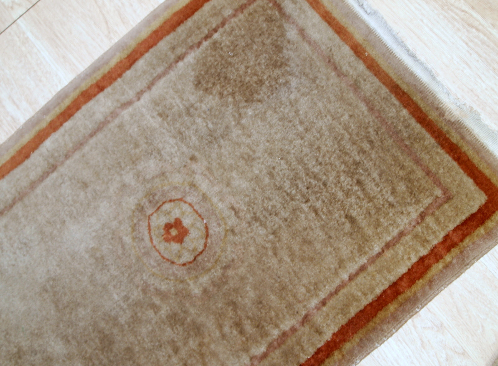 Handmade vintage rug from China made in beige wool. The rug is from the end of 20th century in original good condition.