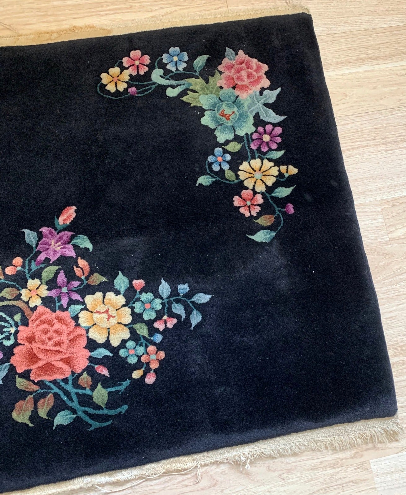 Handmade antique Art Deco Chinese rug in black color with minimal floral design. The rug is from the beginning of 20th century in original good condition.