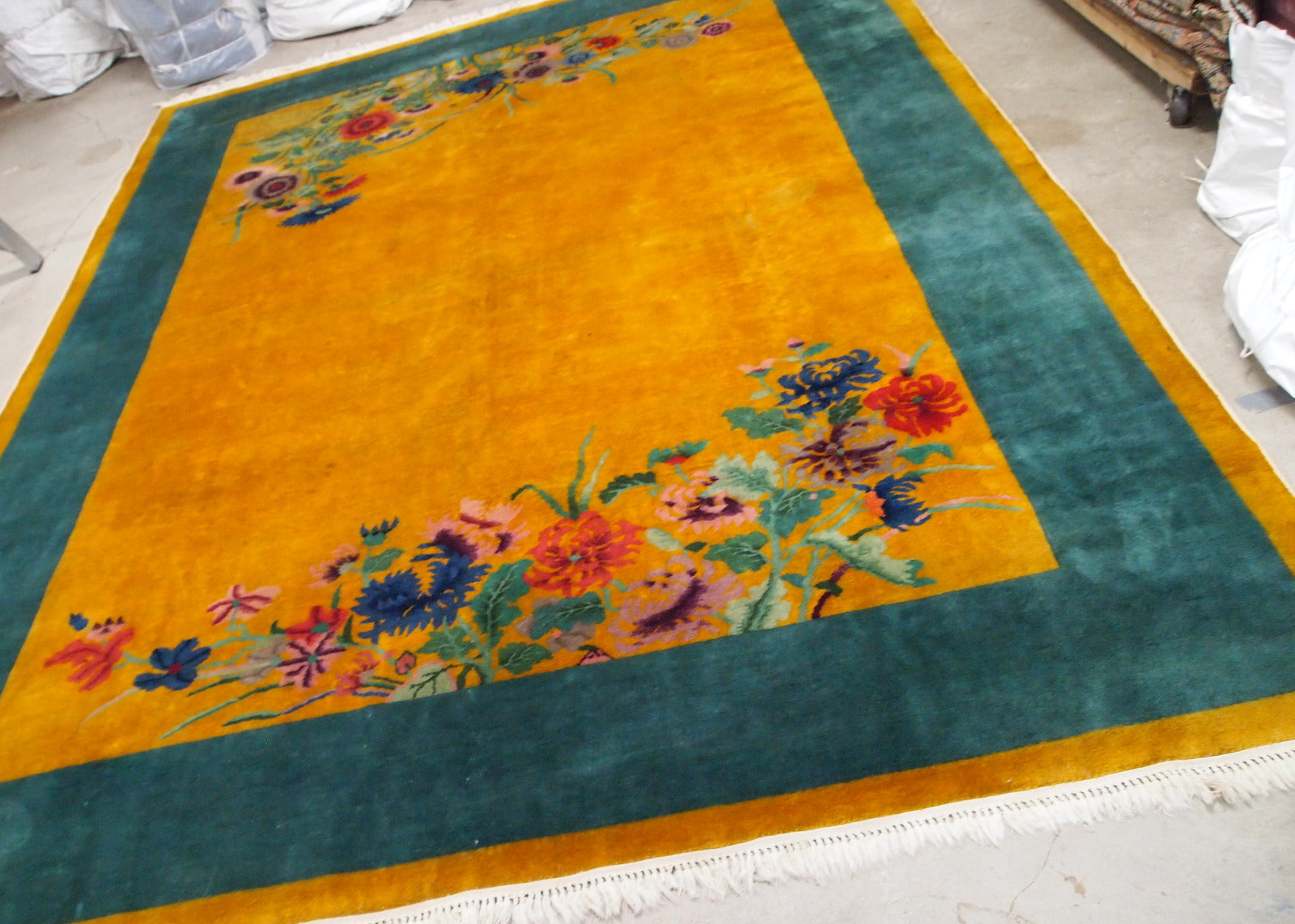 Handmade antique Art Deco Chinese rug in golden and grass green shades. The rug is from the beginning of 20th century in original good condition. 