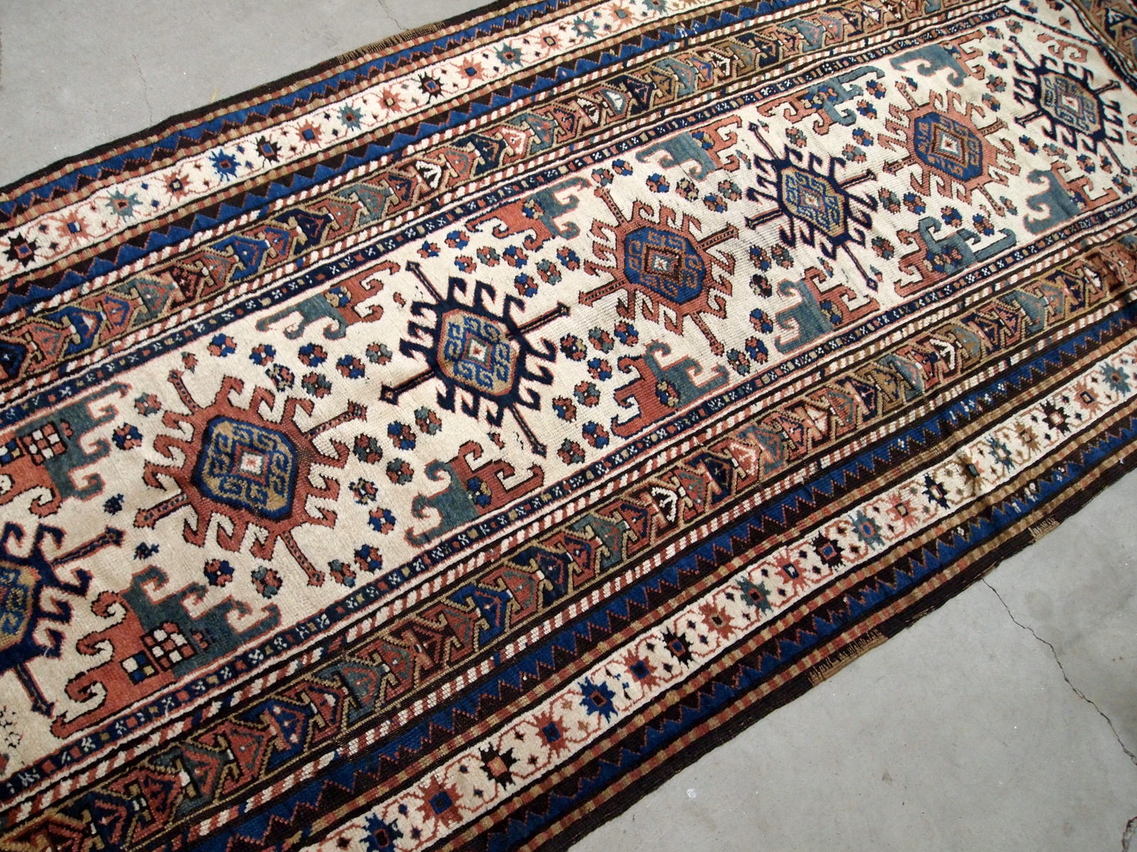 Handmade antique Caucasian Kazak rug in kele size. The rug is from the end of 19th century in original good condition.