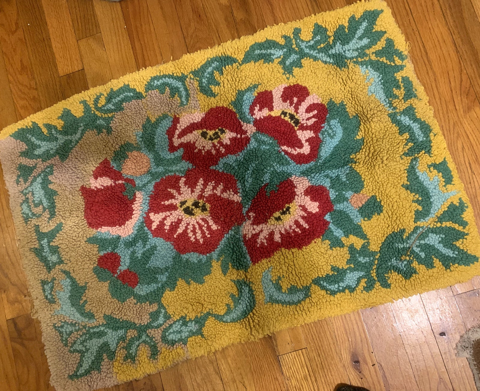 Handmade vintage American Hooked rug in floral design and yellow shade. The rug is from the middle of 20th century in original good condition. 