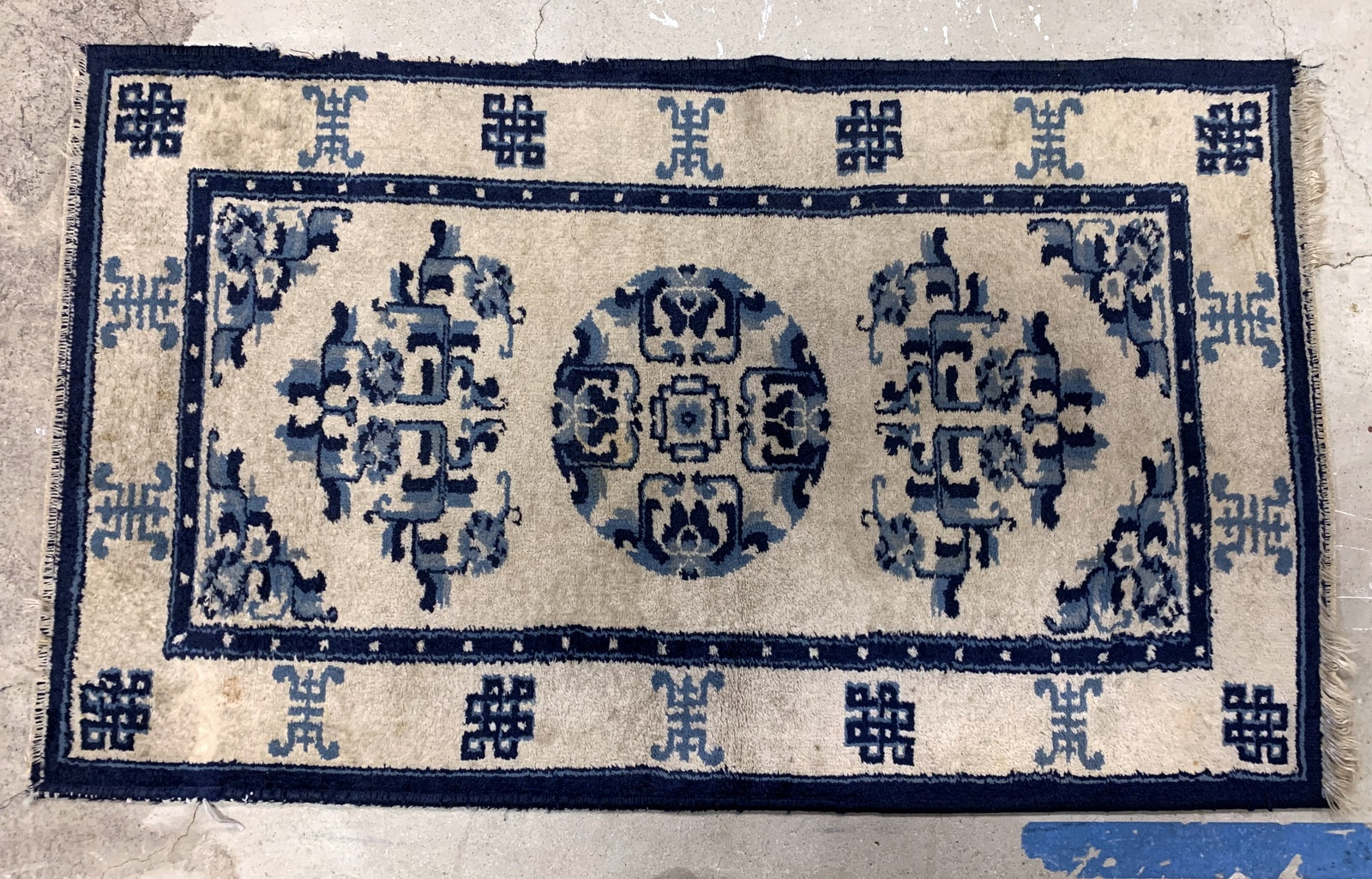 Handmade antique Peking Chinese rug in beige and blue colors. The rug is from the beginning of 20th century in original good condition.