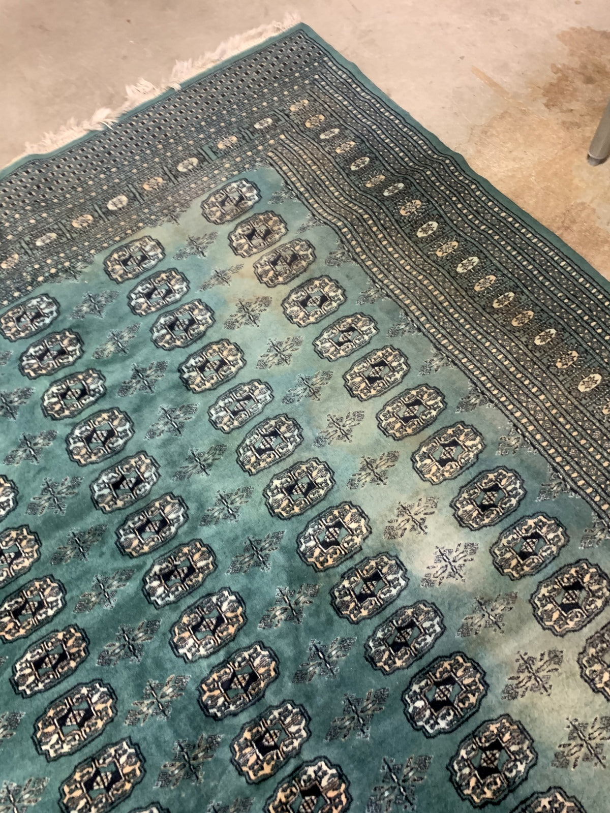 Handmade vintage Uzbek Bukhara rug in Turquoise shade and traditional design. The rug is from the end of 20th century in original condition, it has some age discolorations.