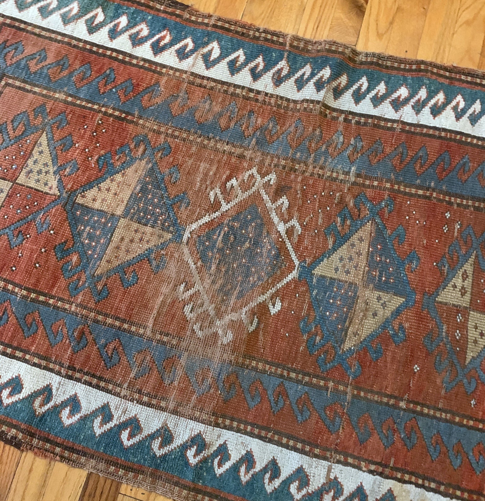 Handmade antique collectible Caucasian Kazak rug in natural dyes. The rug is from the end of 19th century in original condition, it has some age wear