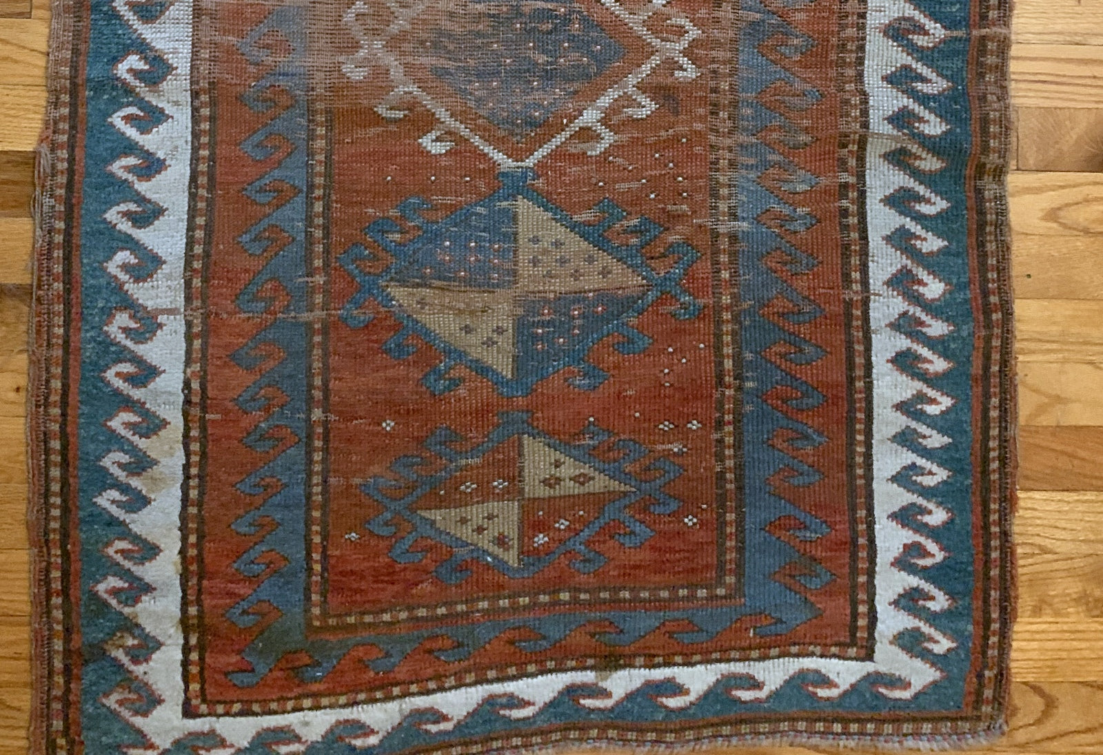 Handmade antique collectible Caucasian Kazak rug in natural dyes. The rug is from the end of 19th century in original condition, it has some age wear