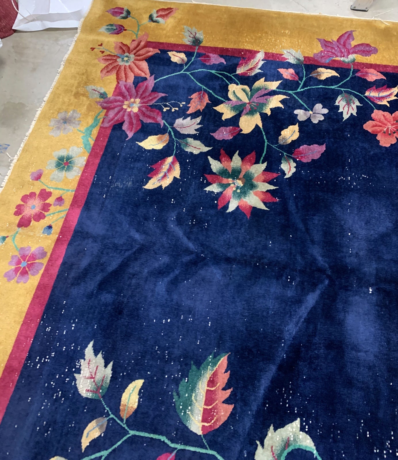 Handmade antique Art Deco Chinese rug in navy blue and golden shades. The rug is from the beginning of 20th century in original condition, it has some low pile. 