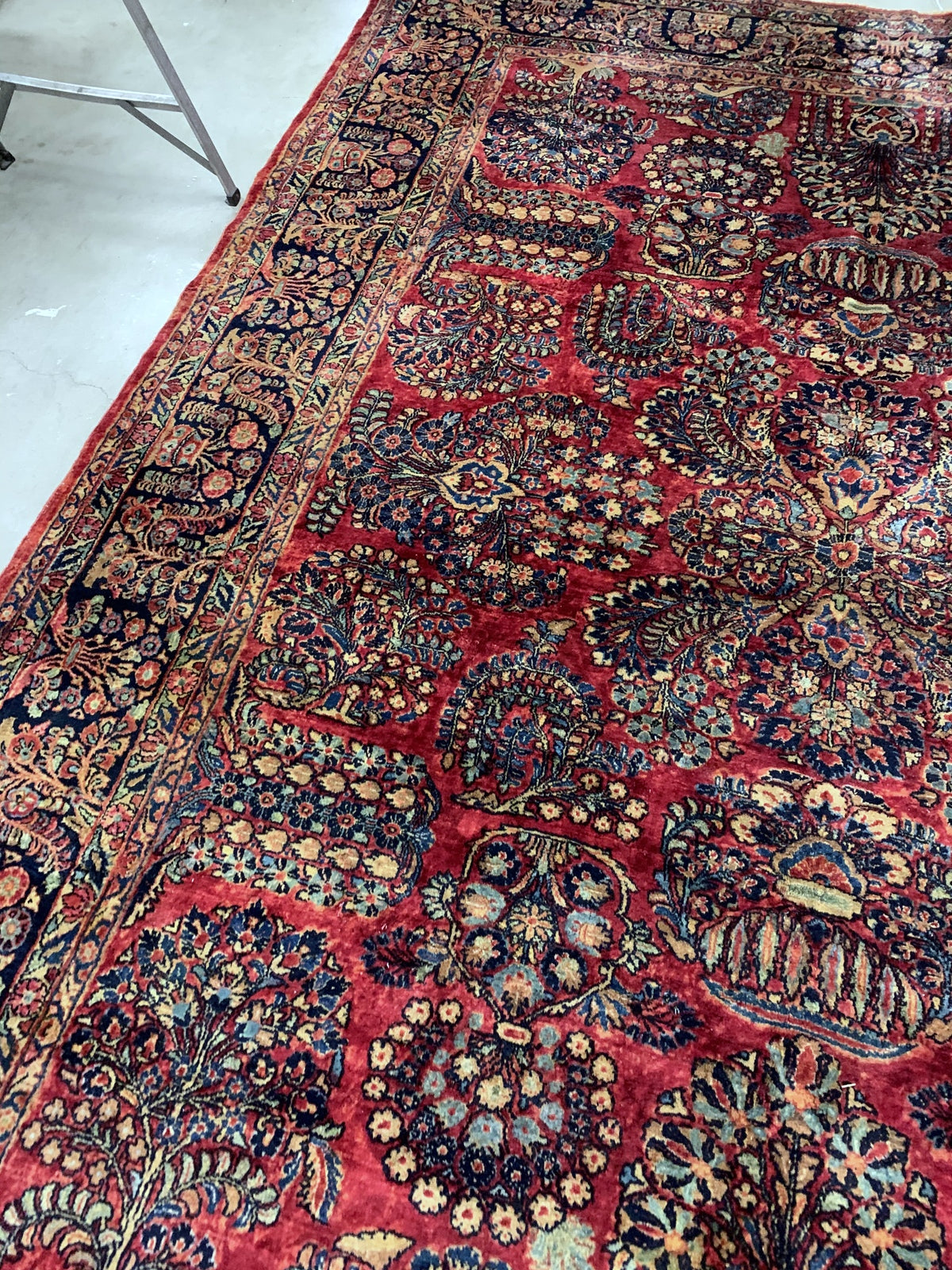Handmade antique Muiddle Eastern rug in traditional floral design. The rug is from the beginning of 20th century in original good condition.