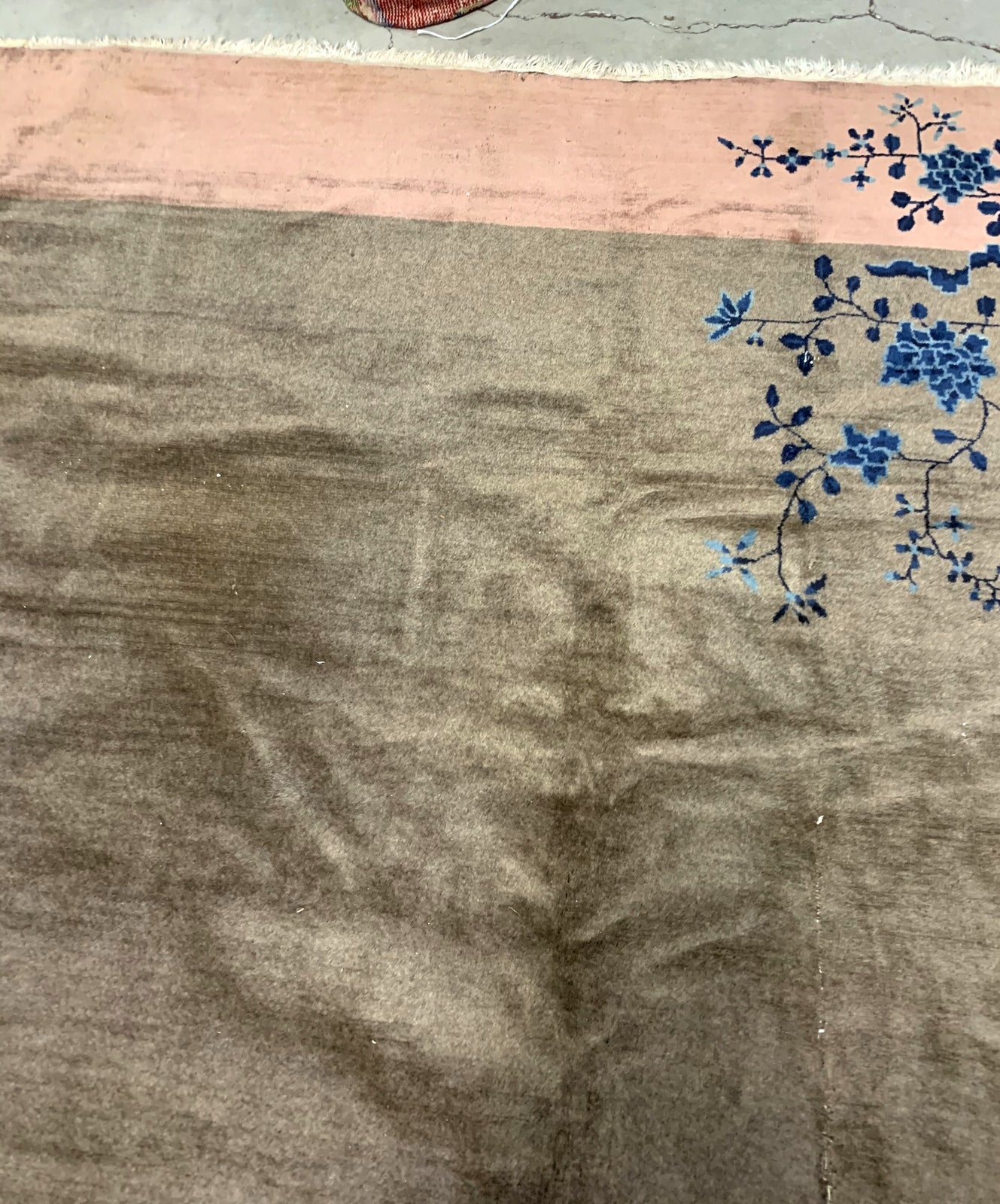 Handmade antique Art Deco Chinese rug in olive green and peach shades. The rug is from the beginning of 20th century in original condition, it has some low pile. 
