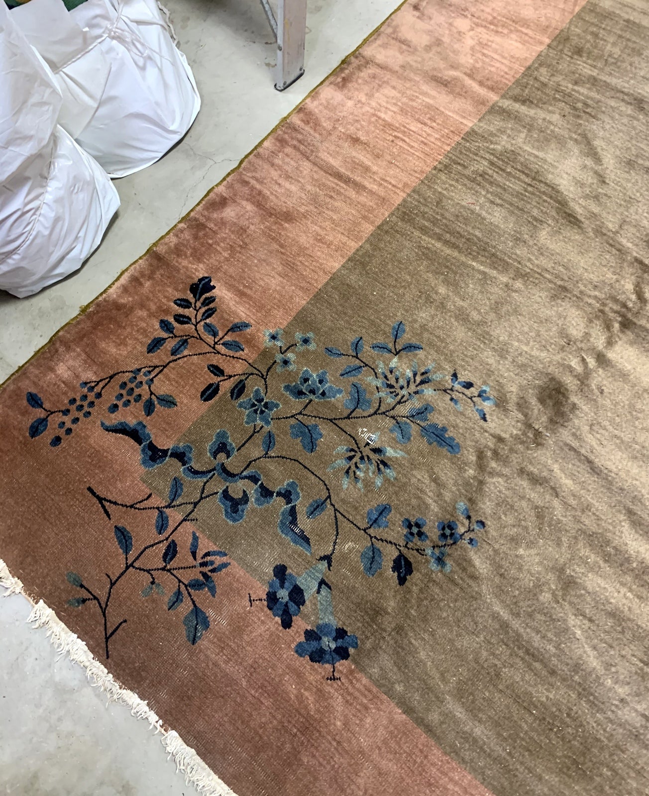 Handmade antique Art Deco Chinese rug in olive green and peach shades. The rug is from the beginning of 20th century in original condition, it has some low pile. 