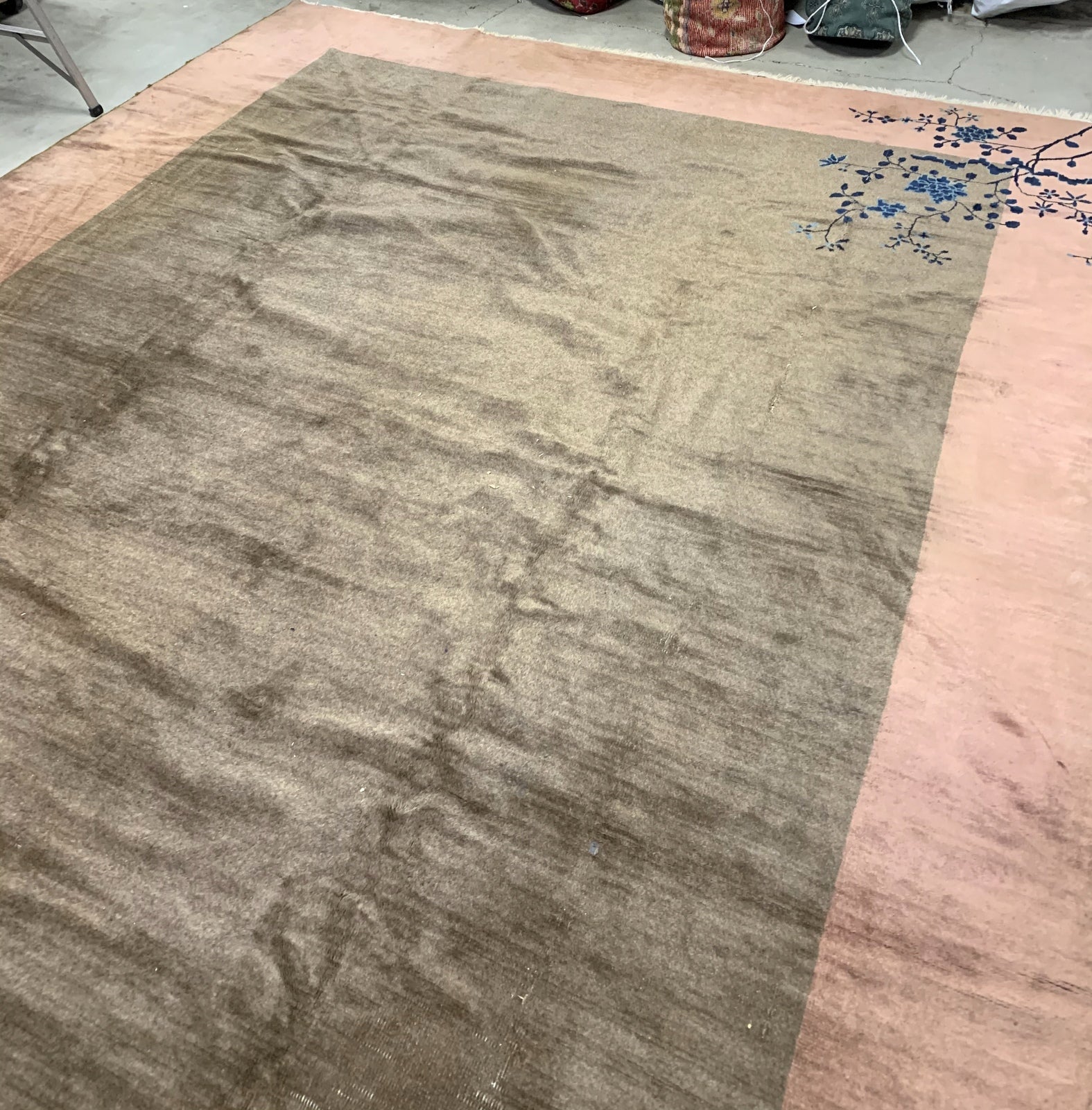 Handmade antique Art Deco Chinese rug in olive green and peach shades. The rug is from the beginning of 20th century in original condition, it has some low pile. 