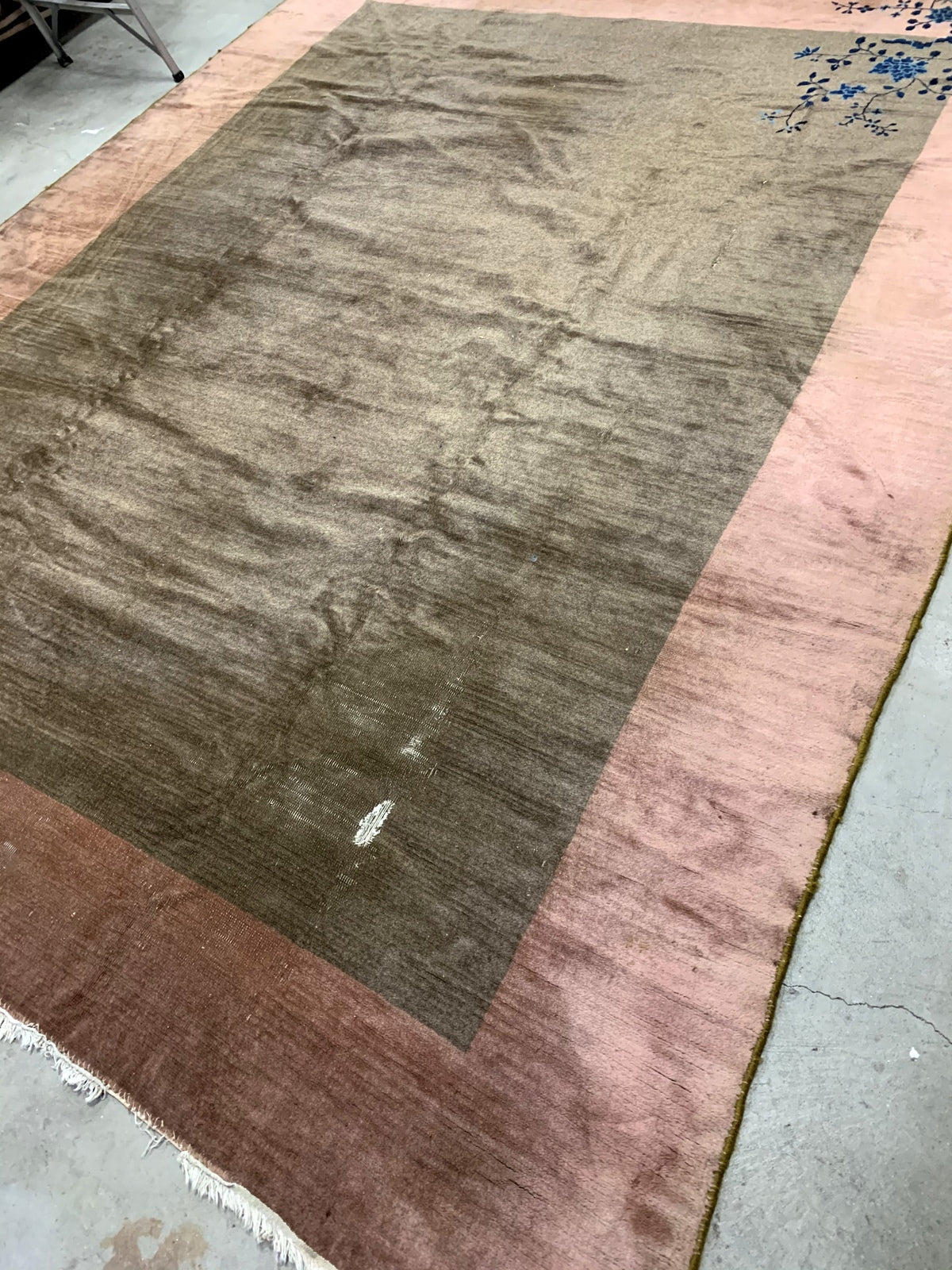 Handmade antique Art Deco Chinese rug in olive green and peach shades. The rug is from the beginning of 20th century in original condition, it has some low pile. 