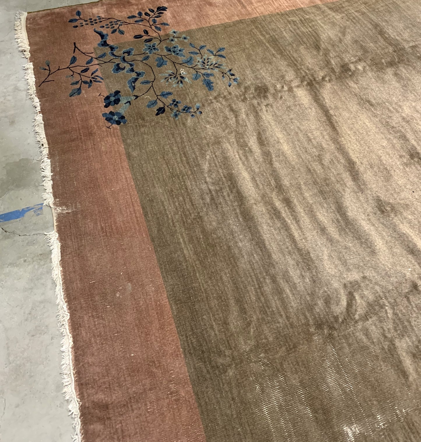 Handmade antique Art Deco Chinese rug in olive green and peach shades. The rug is from the beginning of 20th century in original condition, it has some low pile. 