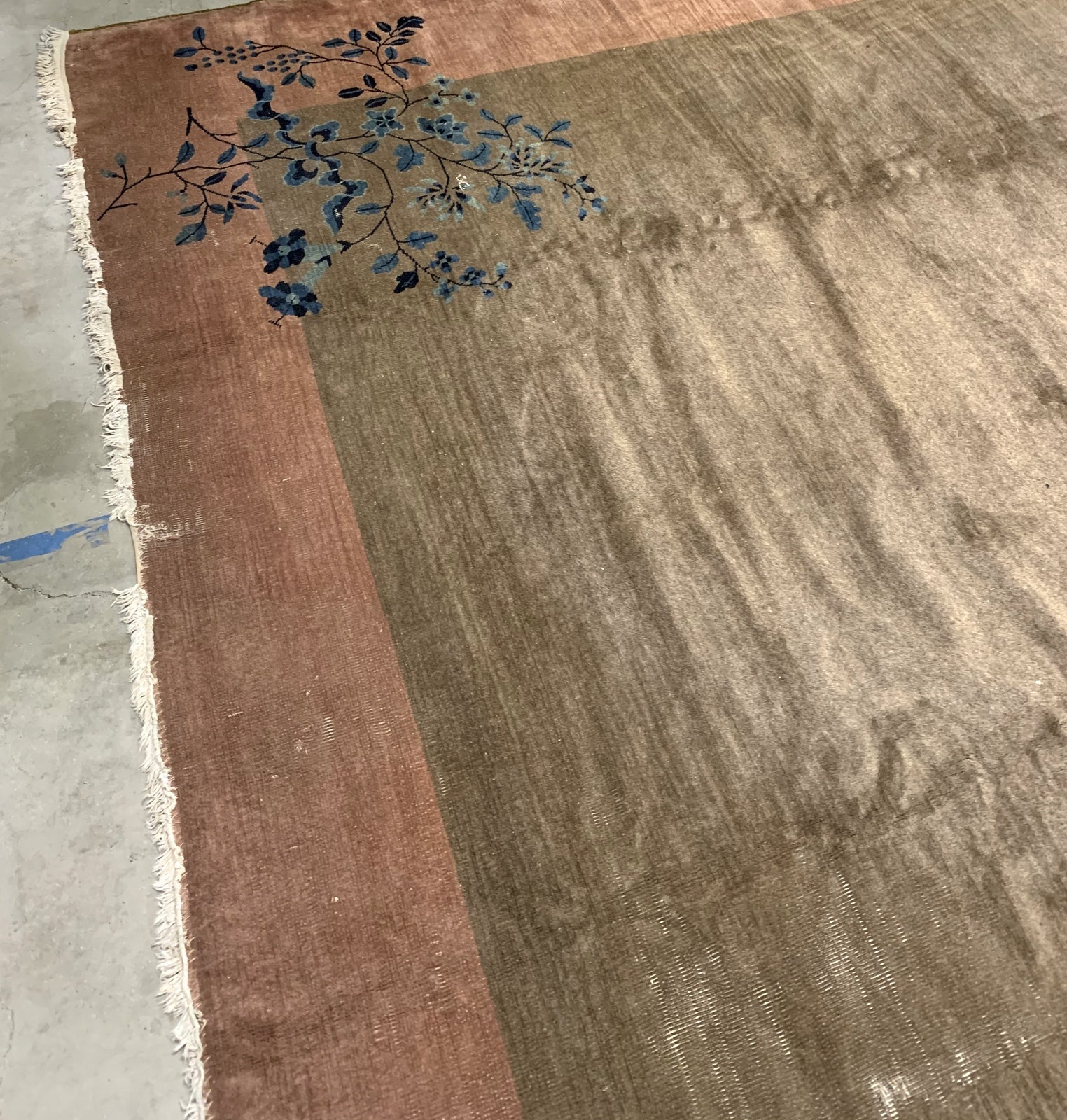 Handmade antique Art Deco Chinese rug in olive green and peach shades. The rug is from the beginning of 20th century in original condition, it has some low pile. 