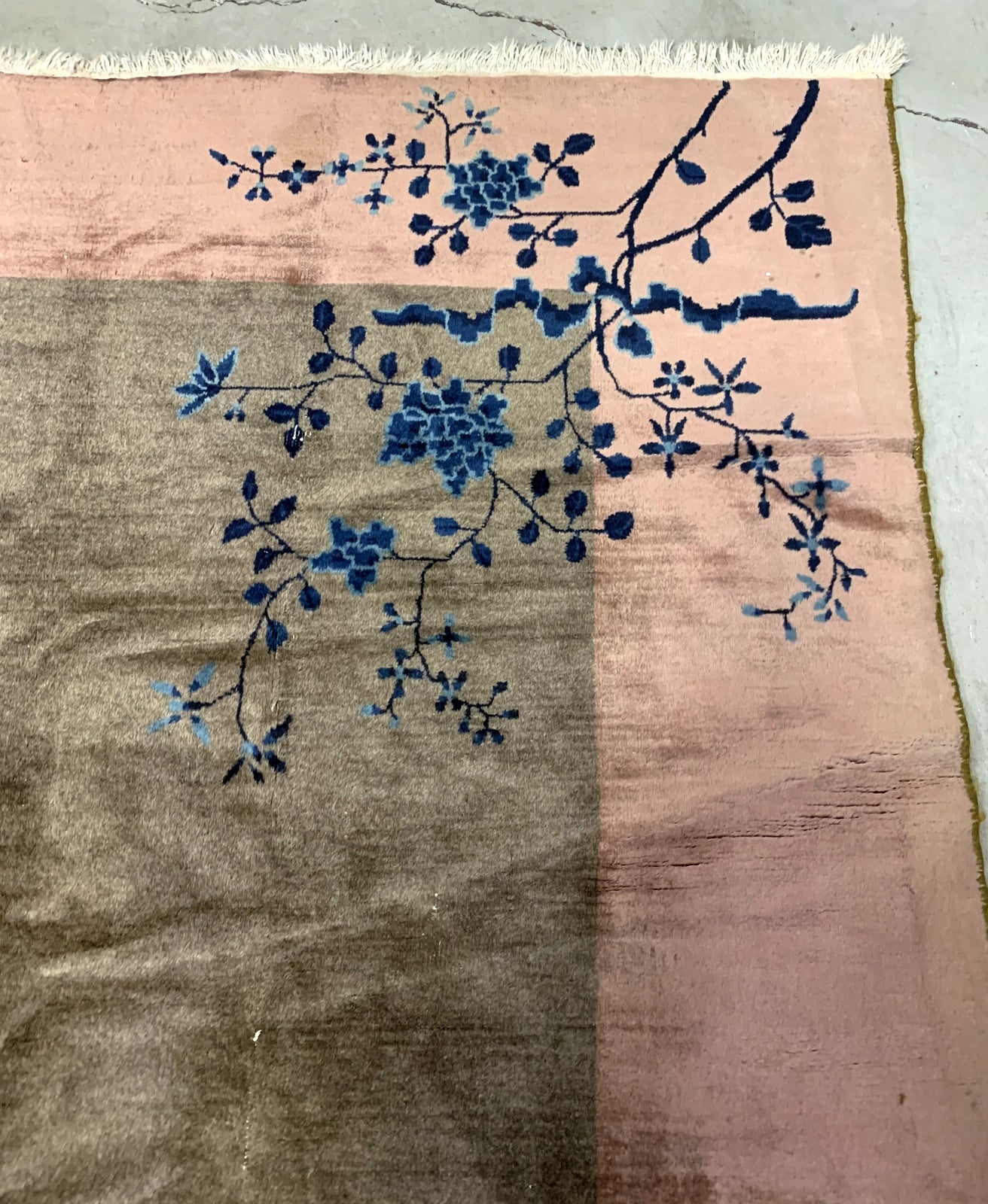 Handmade antique Art Deco Chinese rug in olive green and peach shades. The rug is from the beginning of 20th century in original condition, it has some low pile. 