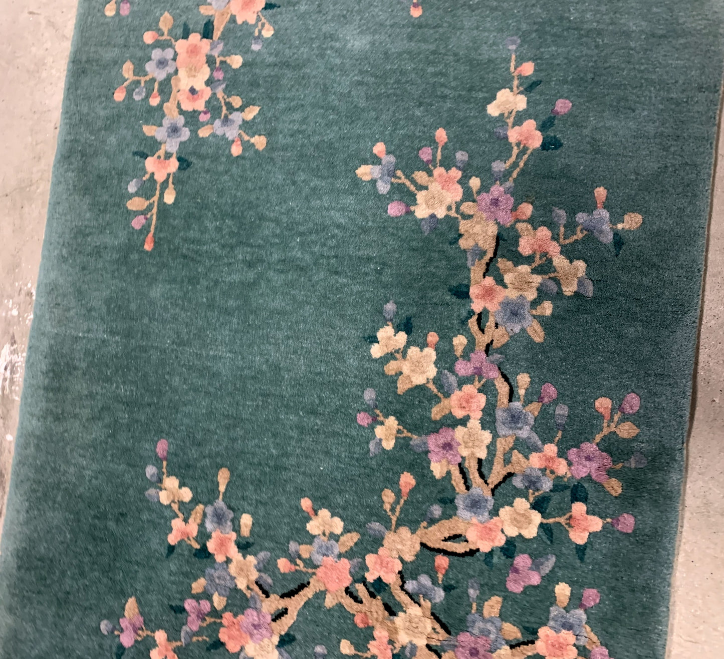 Handmade antique Art Deco Chinese rug in green shade with floral design. The rug is from the beginning of 20th century in original good condition. 