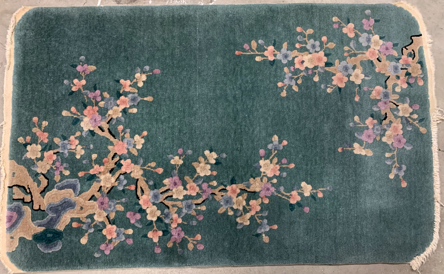 Handmade antique Art Deco Chinese rug in green shade with floral design. The rug is from the beginning of 20th century in original good condition. 