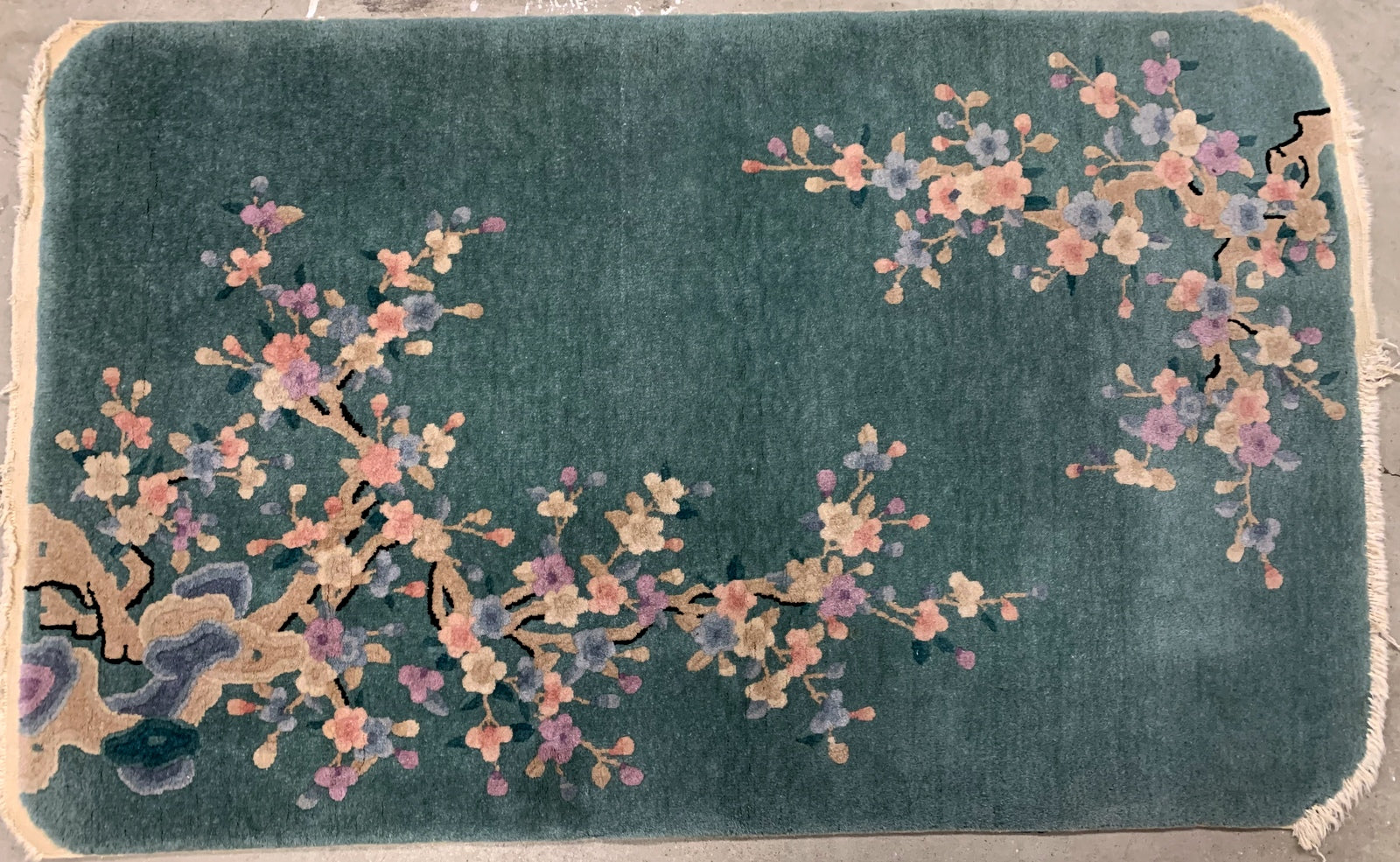 Handmade antique Art Deco Chinese rug in green shade with floral design. The rug is from the beginning of 20th century in original good condition. 