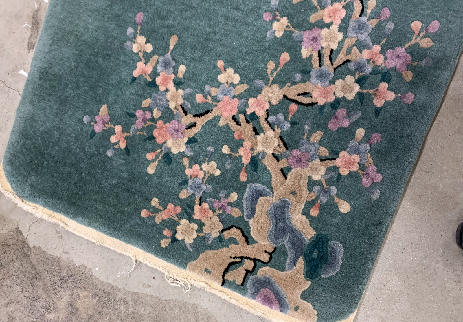 Handmade antique Art Deco Chinese rug in green shade with floral design. The rug is from the beginning of 20th century in original good condition. 