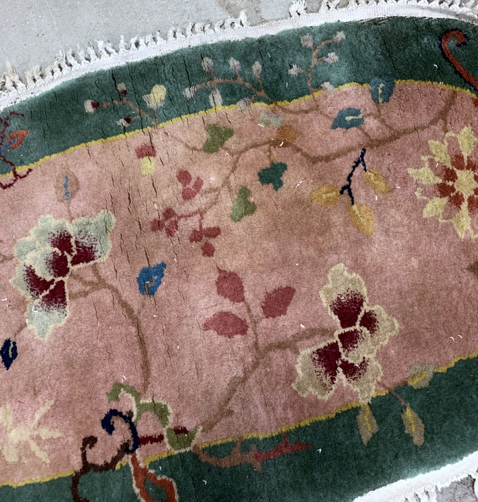 Handmade antique Art Deco Chinese rug in light burgundy and green color. The rug is from the beginning of 20th century in original good condition. 
