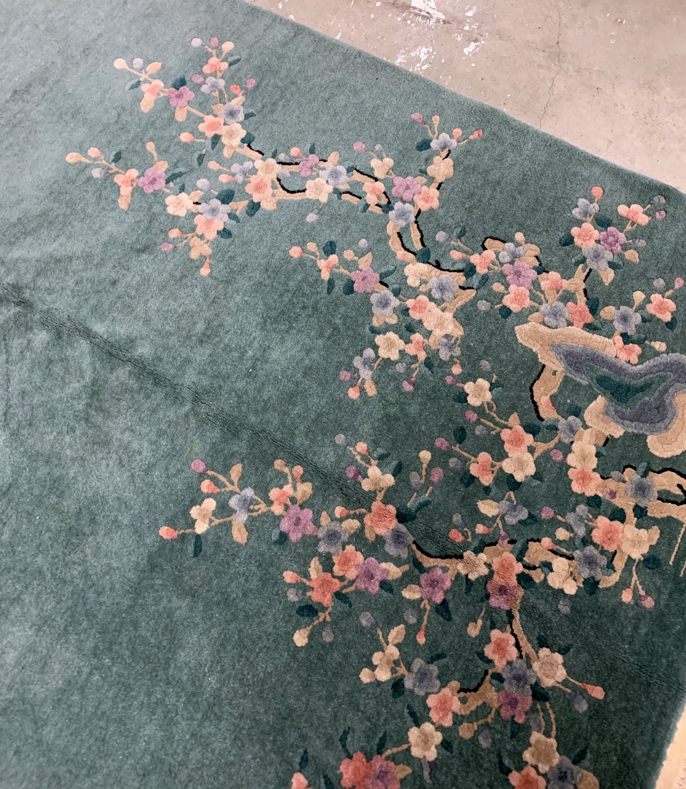 Handmade antique Art Deco Chinese rug in green shade with floral design. The rug is from the beginning of 20th century in original good condition. 