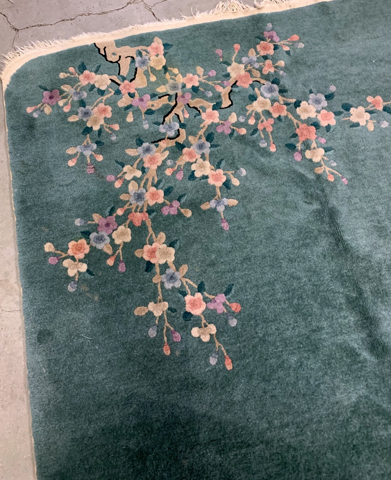 Handmade antique Art Deco Chinese rug in green shade with floral design. The rug is from the beginning of 20th century in original good condition. 