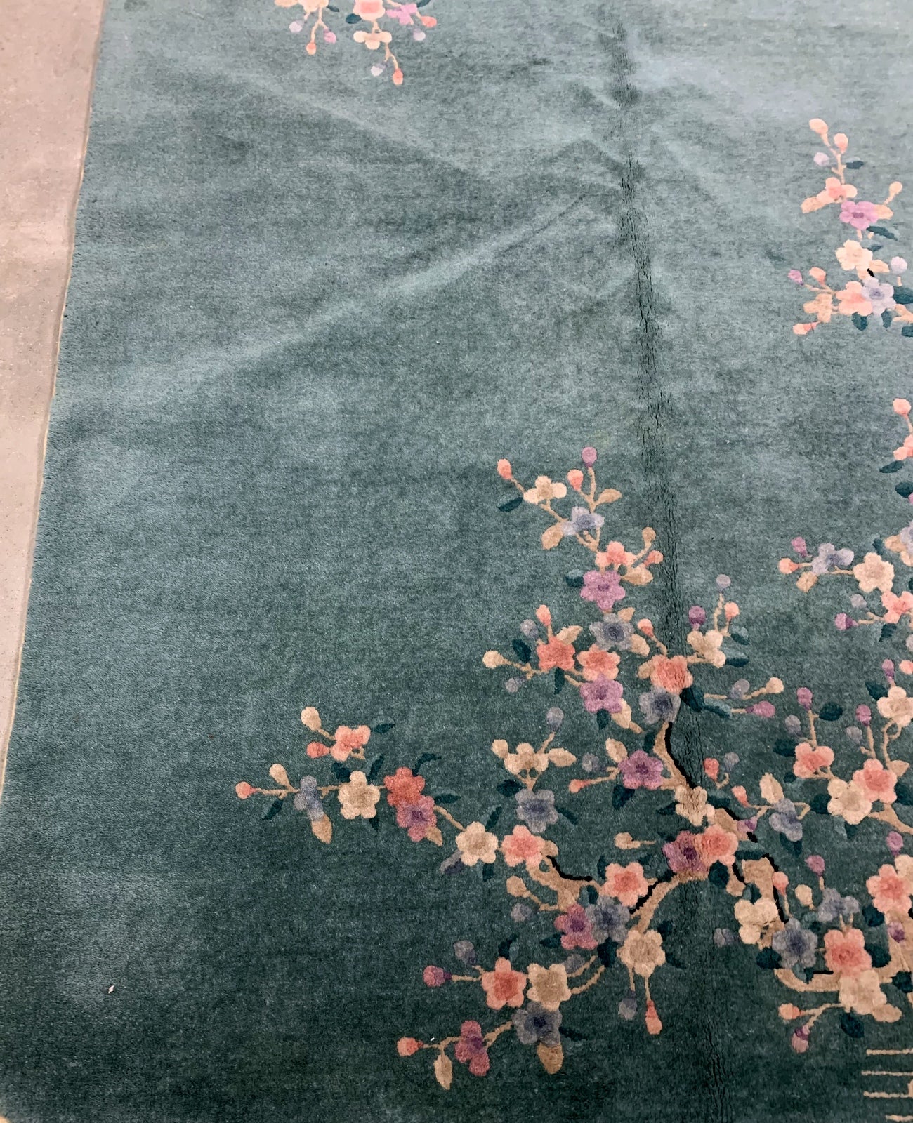 Handmade antique Art Deco Chinese rug in green shade with floral design. The rug is from the beginning of 20th century in original good condition. 