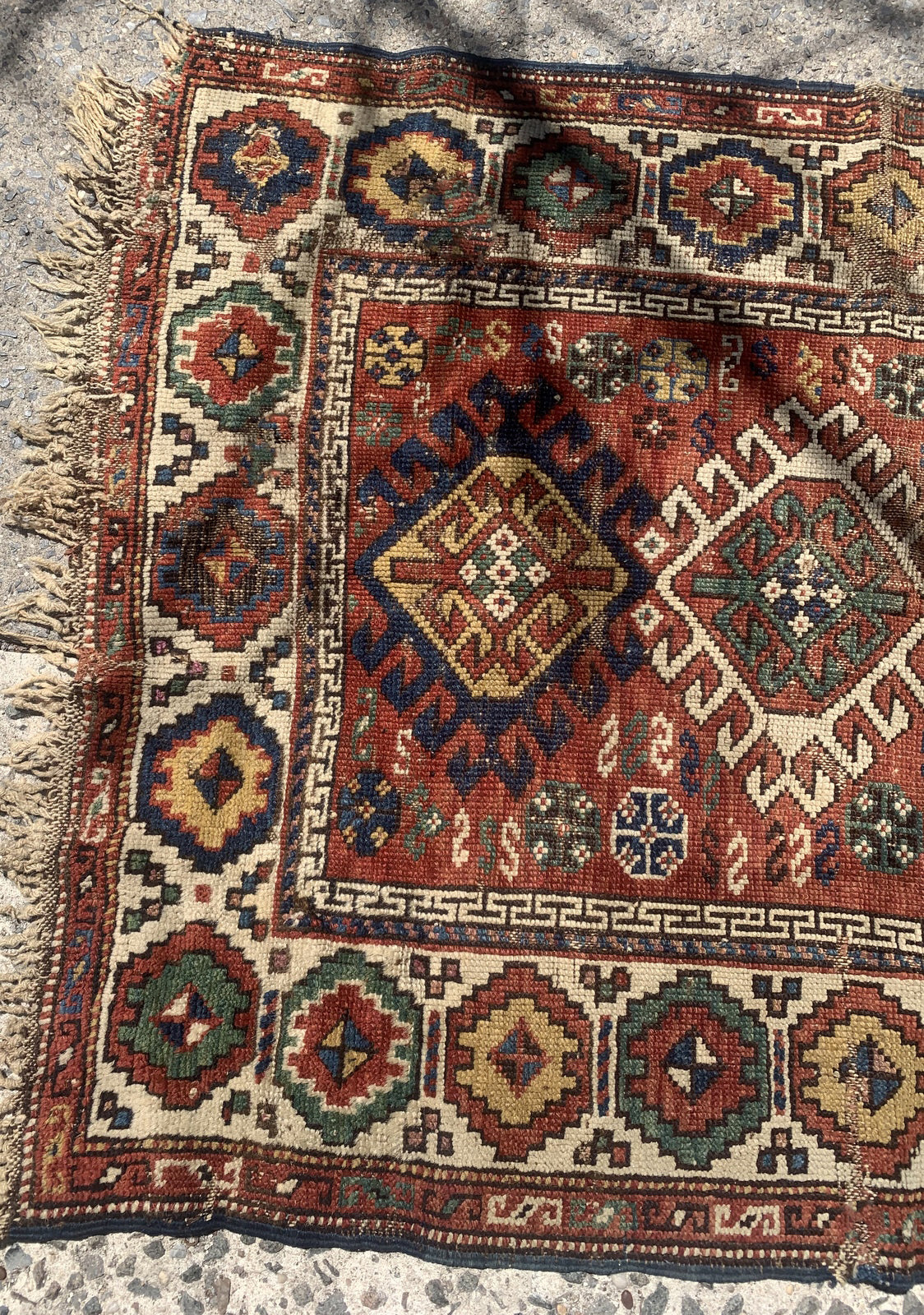 Handmade antique Caucasian Kazak rug in red color. The rug is from the end of 19th century in distressed condition.