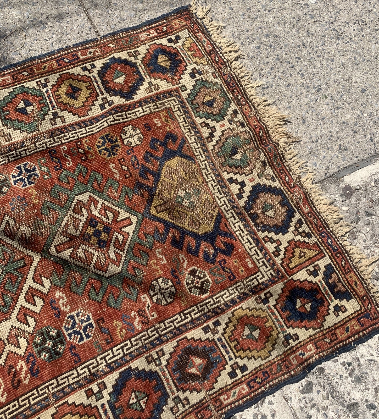 Handmade antique Caucasian Kazak rug in red color. The rug is from the end of 19th century in distressed condition.