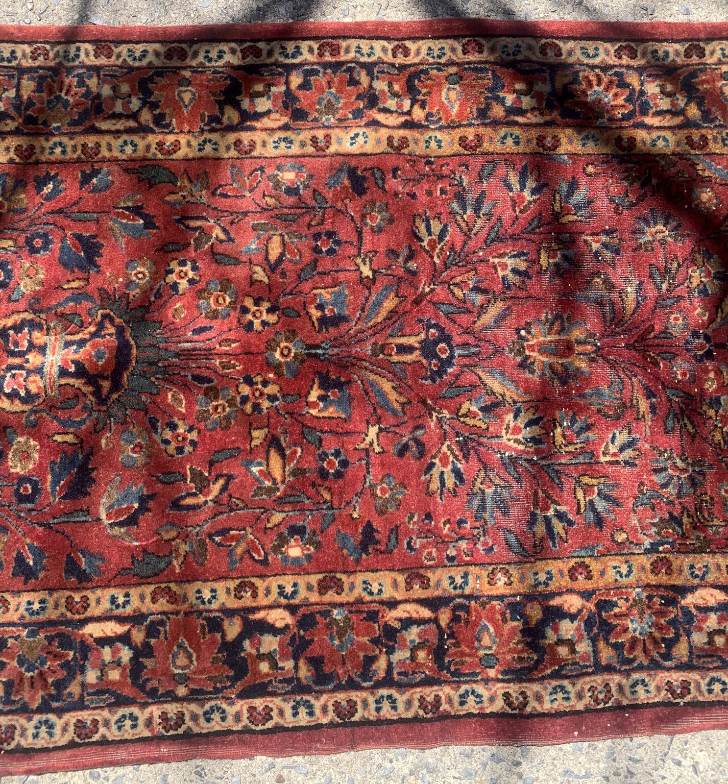 Handmade antique Persian Sarouk rug in red color. The rug is from the beginning of 20th century in original condition, it has some low pile. This rug is prayer.