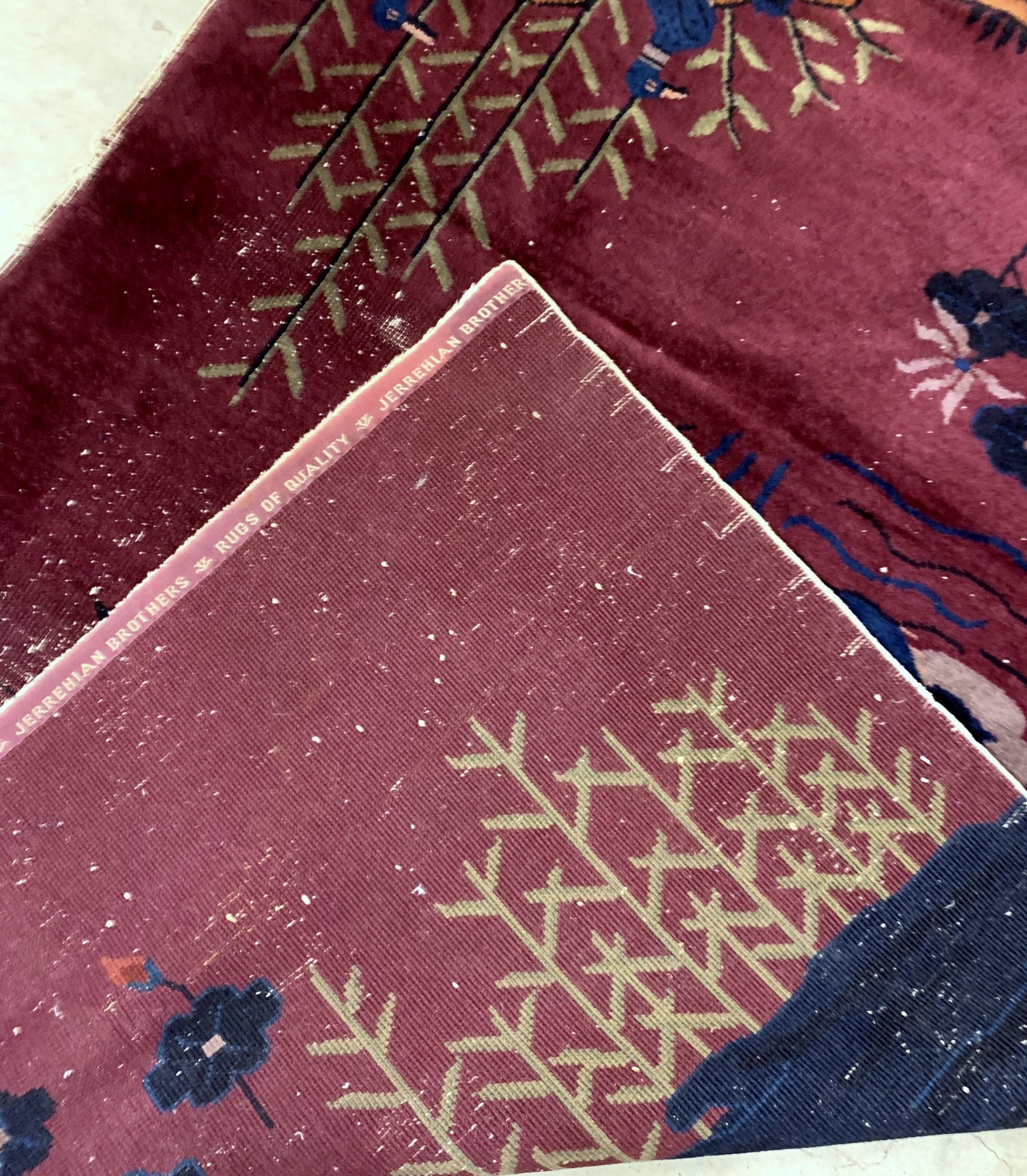 Handmade antique Art Deco Chinese rug in burgundy color with some ducks design. The rug is from the beginning of 20th century in original condition, it has some low pile.