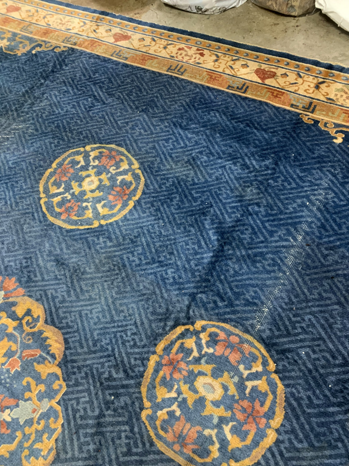 Handmade antique Peking Chinese rug in blue and beige colors. The rug is from the beginning of 20th century in original condition, it has some distressed areas.