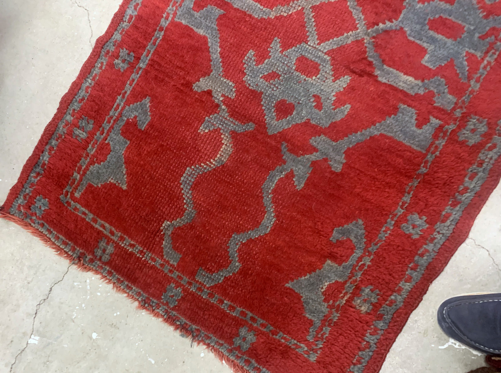 Handmade antique Turkish red rug from Oushak region. The rug is from the end of 19th century in original condition, it has some signs of age.