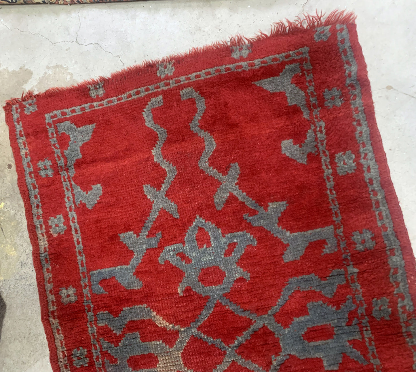 Handmade antique Turkish red rug from Oushak region. The rug is from the end of 19th century in original condition, it has some signs of age.