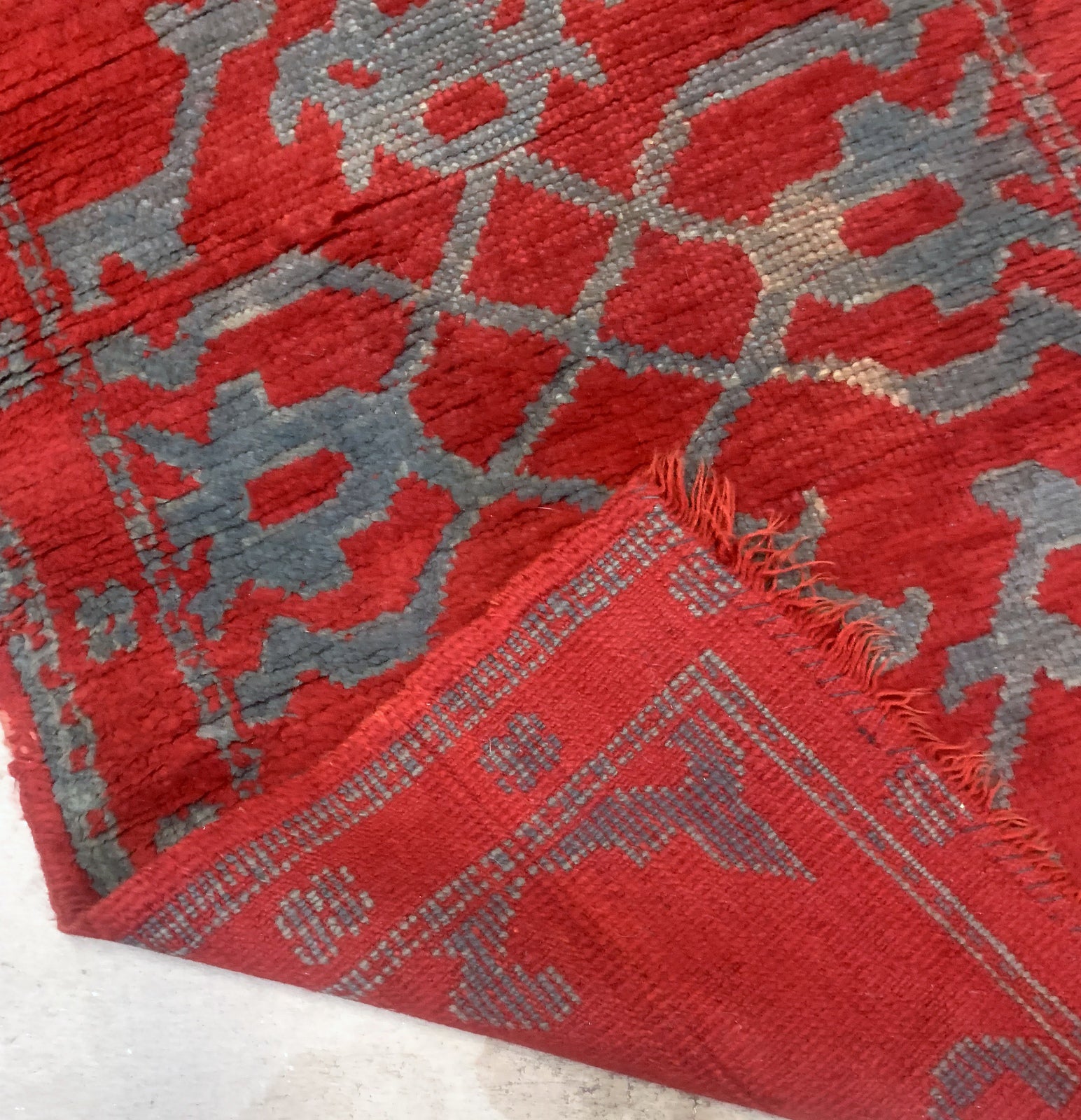 Handmade antique Turkish red rug from Oushak region. The rug is from the end of 19th century in original condition, it has some signs of age.