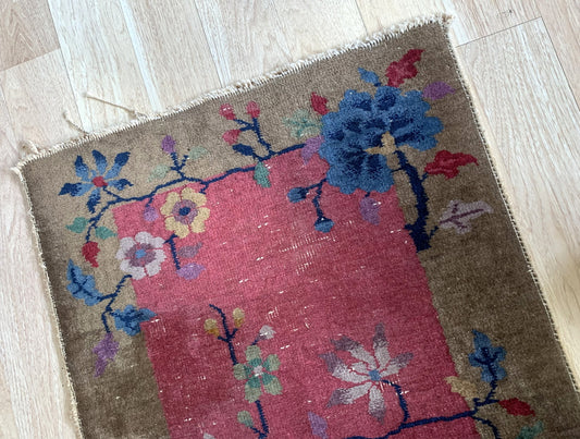 Close-up of exquisite floral motifs on a vintage Chinese Art Deco rug from the 1920s.