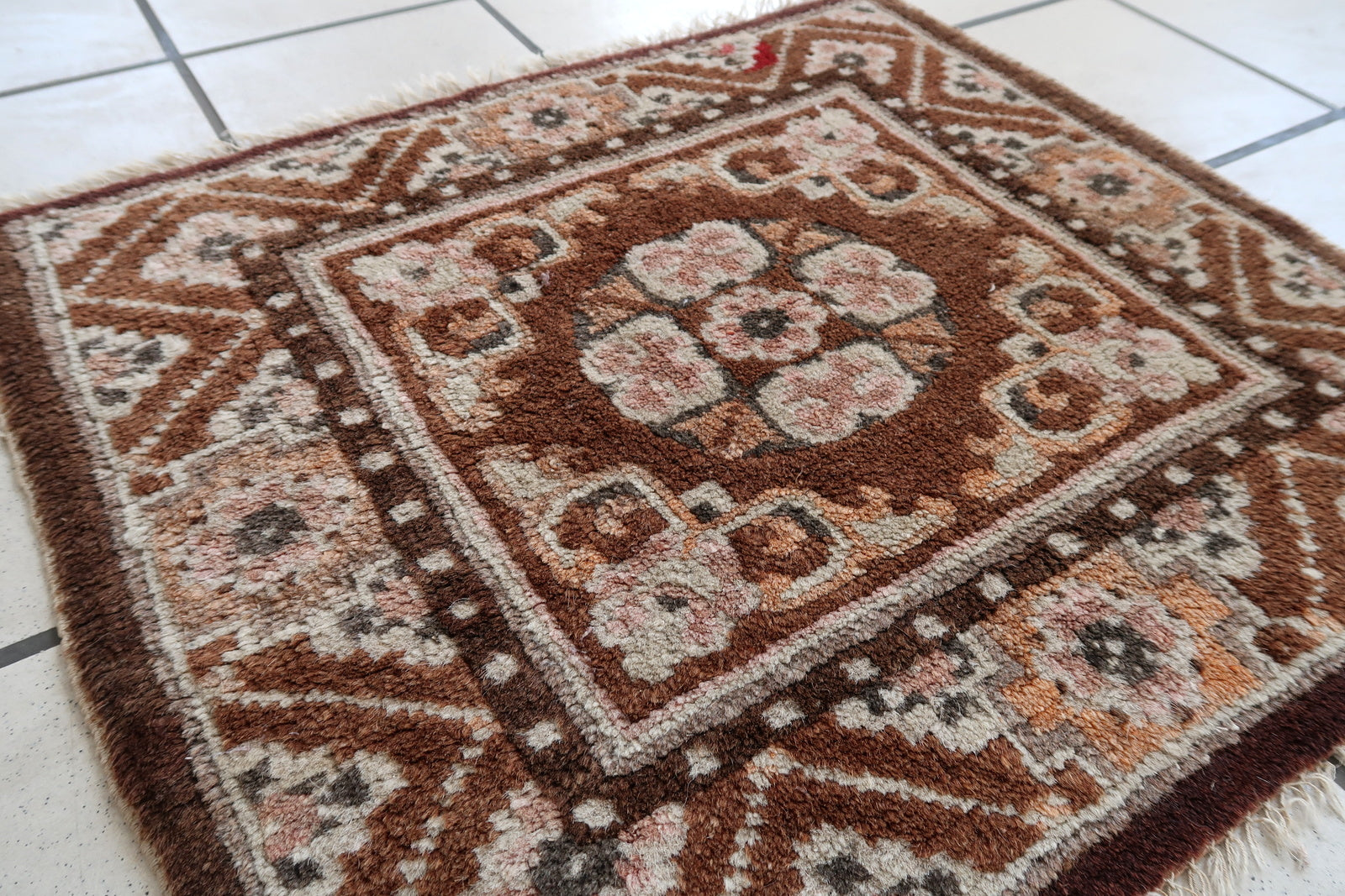Handmade vintage Mongolian collectible mat in brown shade. The rug is from the middle of 20th century in original good condition.