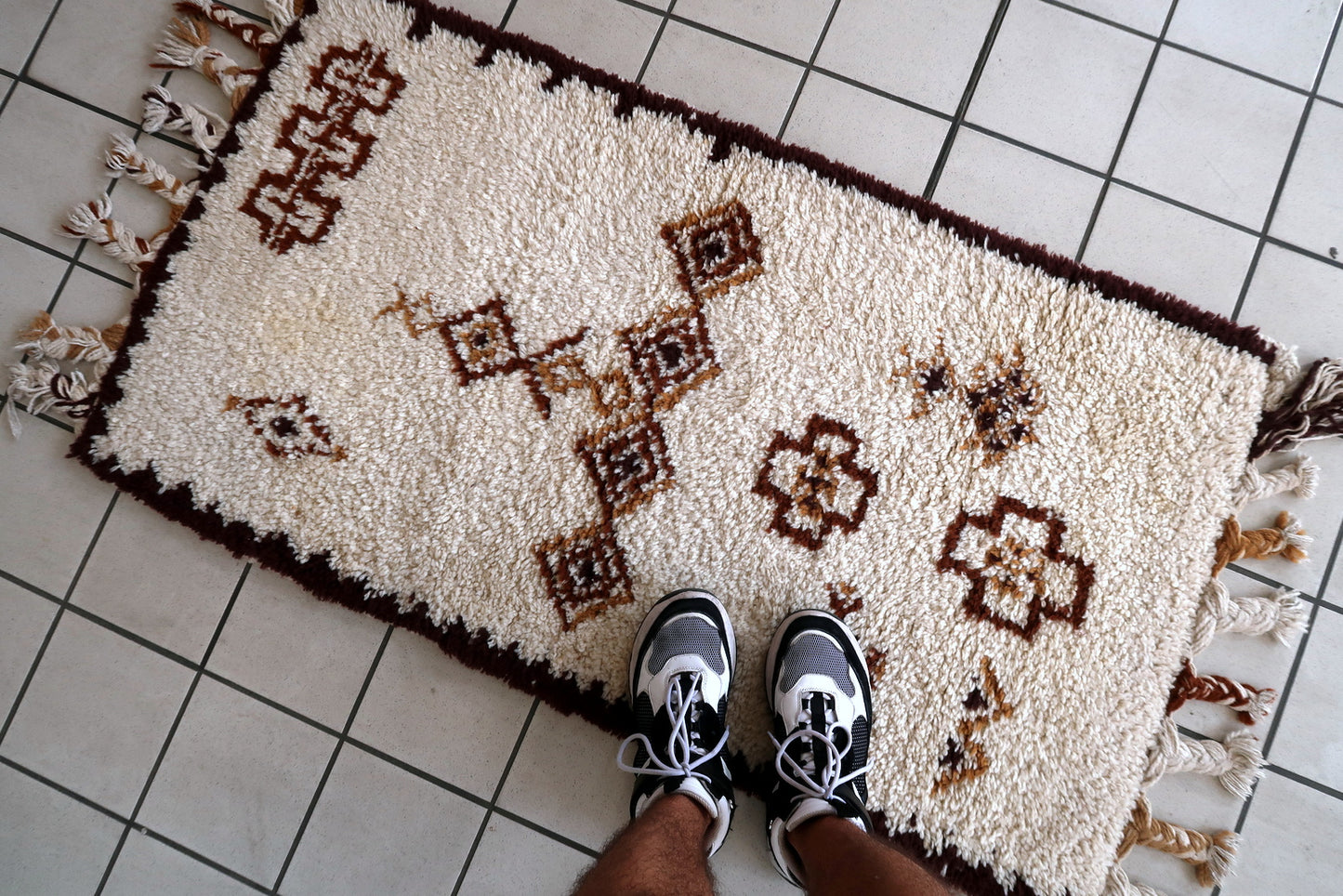 Handmade vintage Moroccan Berber woolen  rug in white and brown colors. The rug is from the end of 20th century in original good condition.