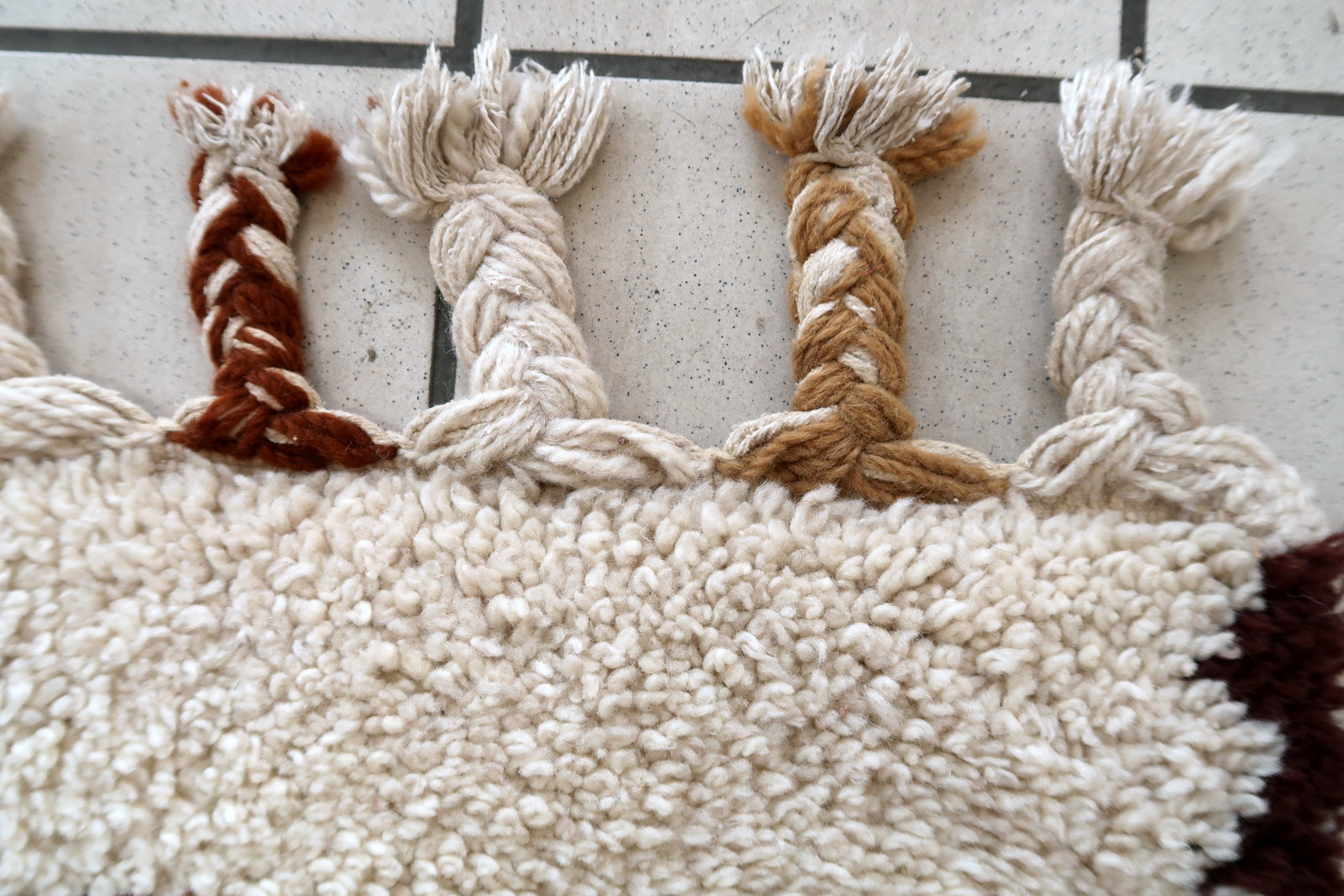 Handmade vintage Moroccan Berber woolen  rug in white and brown colors. The rug is from the end of 20th century in original good condition.