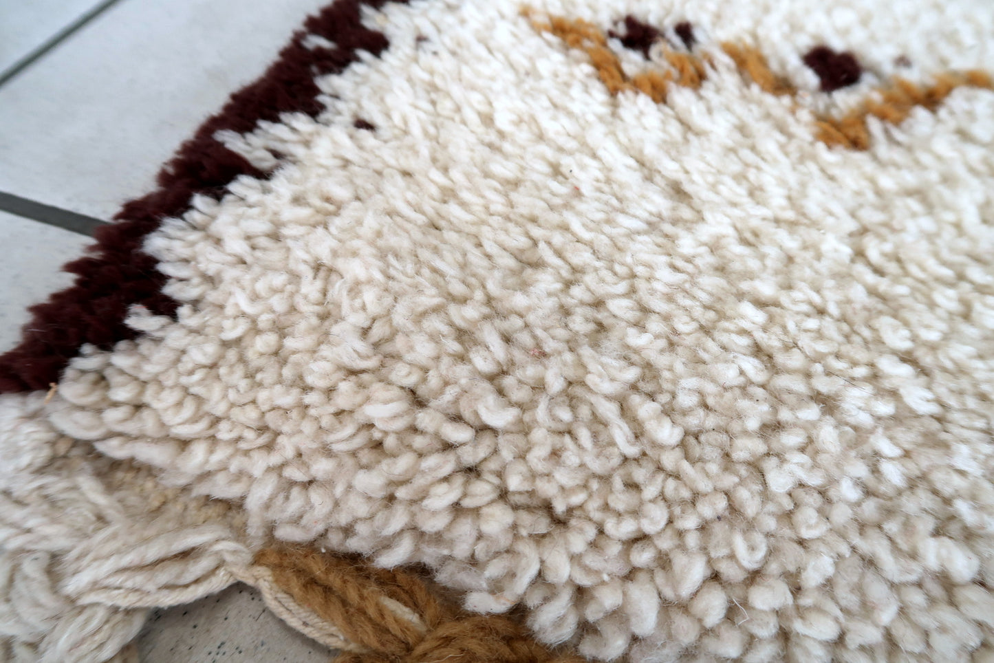 Handmade vintage Moroccan Berber woolen  rug in white and brown colors. The rug is from the end of 20th century in original good condition.