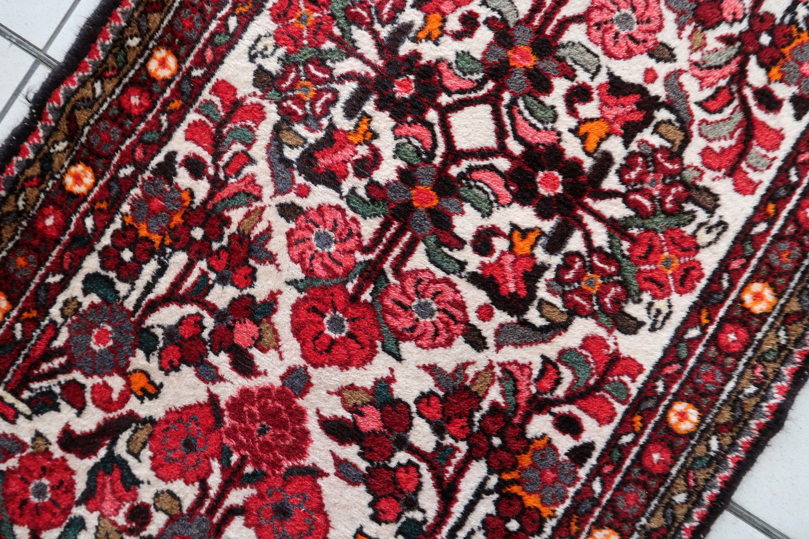 Handmade antique Persian Malayer runner in floral design. The runner is from the beginning of 20th century in original good condition.