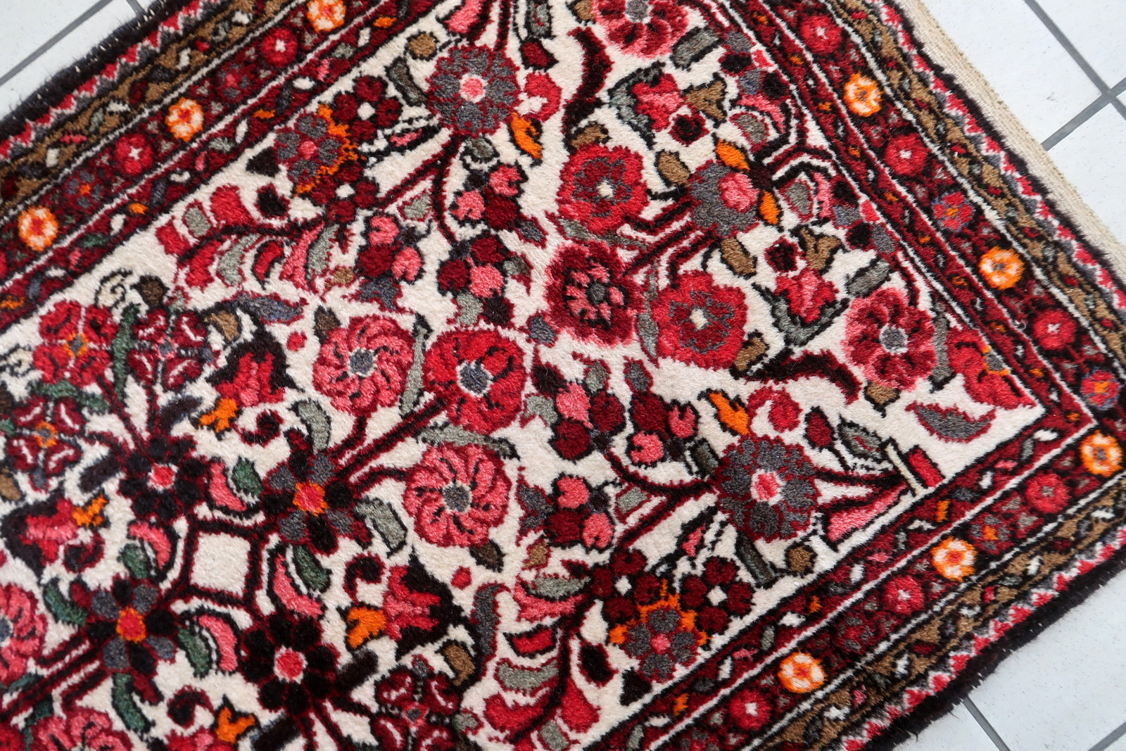 Handmade antique Persian Malayer runner in floral design. The runner is from the beginning of 20th century in original good condition.