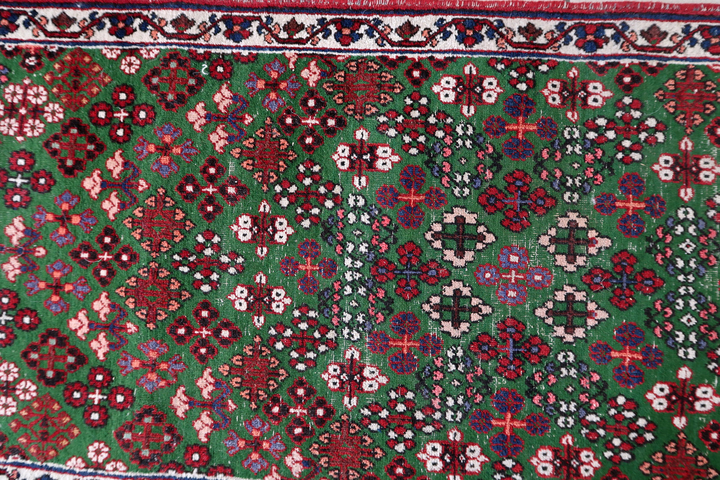 Handmade antique Persian Joshagan runner in green color. The runner is from the beginning of 20th century in original condition, it has some low pile.